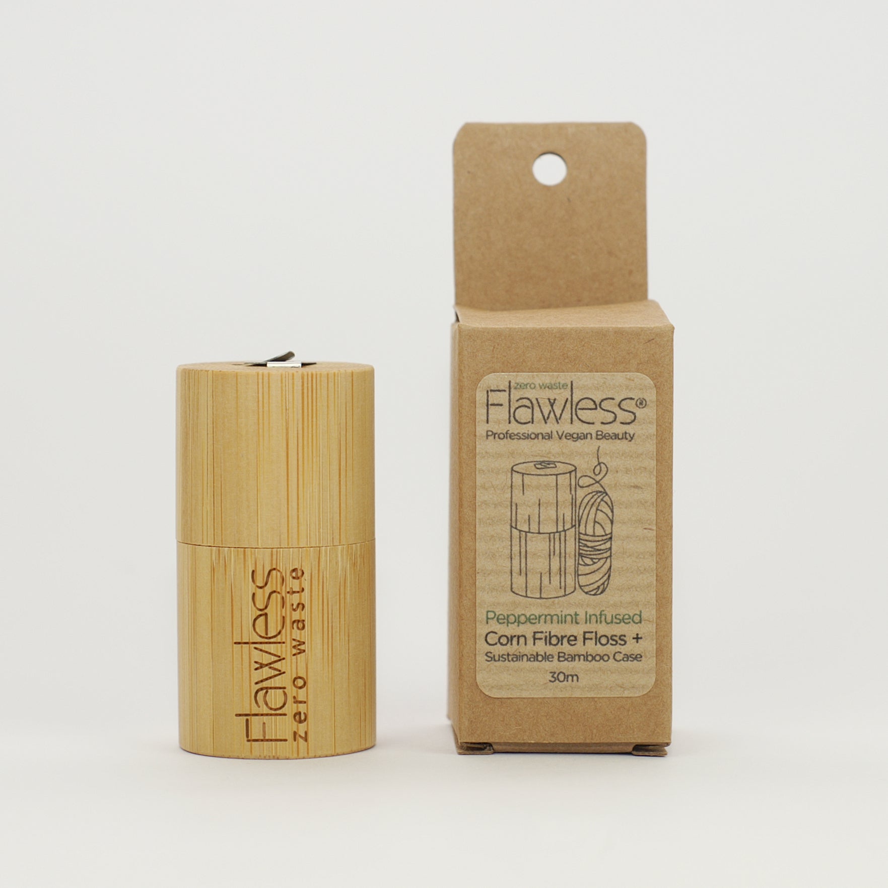 Eco-friendly compostable dental floss in a bamboo dispenser, infused with peppermint oil for fresh breath.