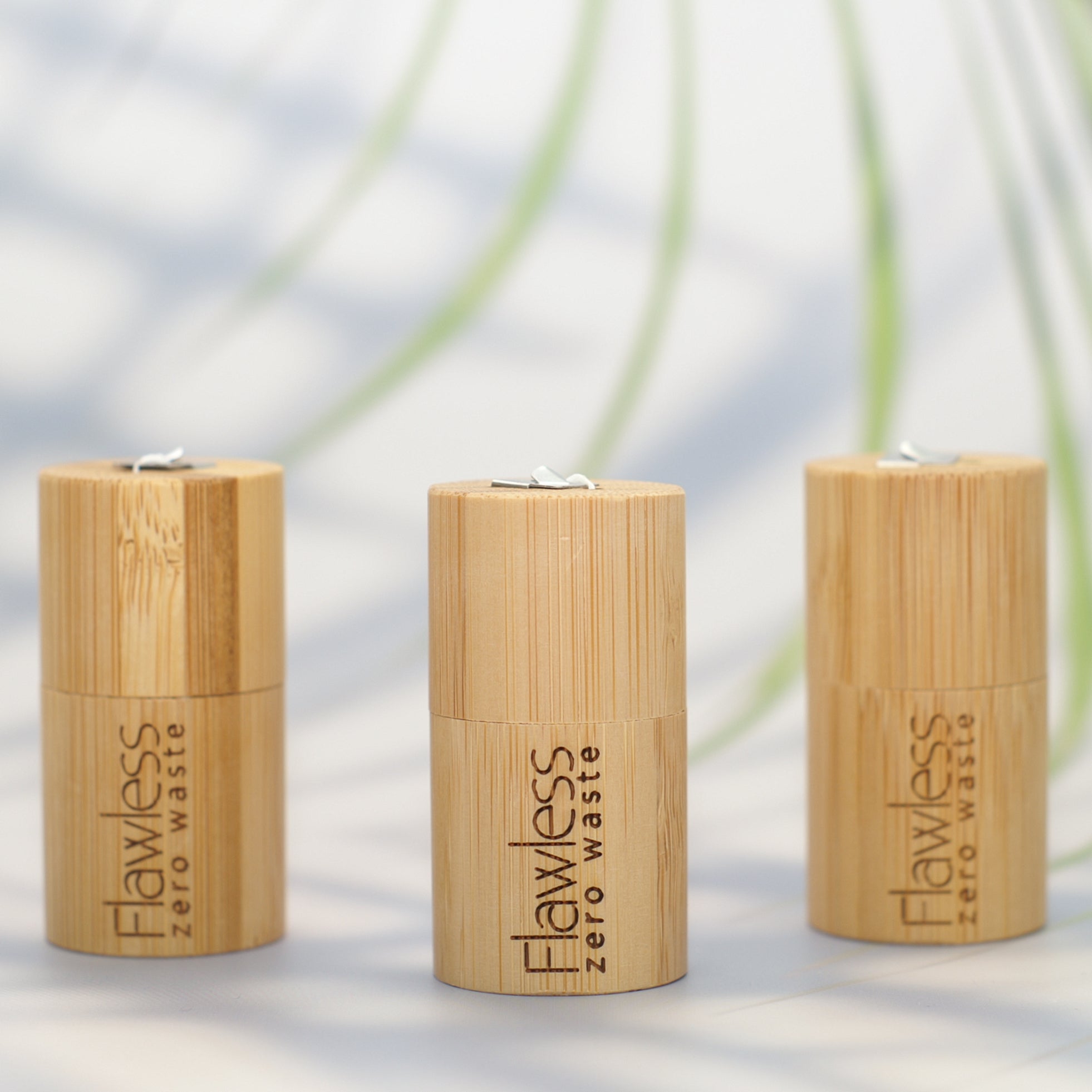 Eco-friendly compostable dental floss in a bamboo dispenser, infused with peppermint oil for fresh breath.