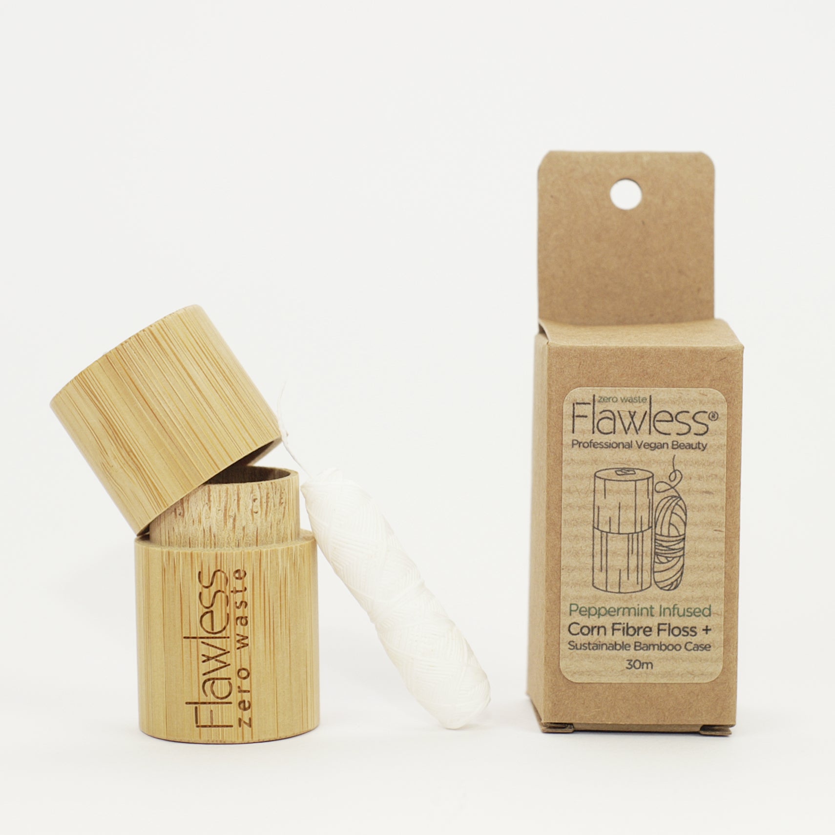 Eco-friendly compostable dental floss in a bamboo dispenser, infused with peppermint oil for fresh breath.
