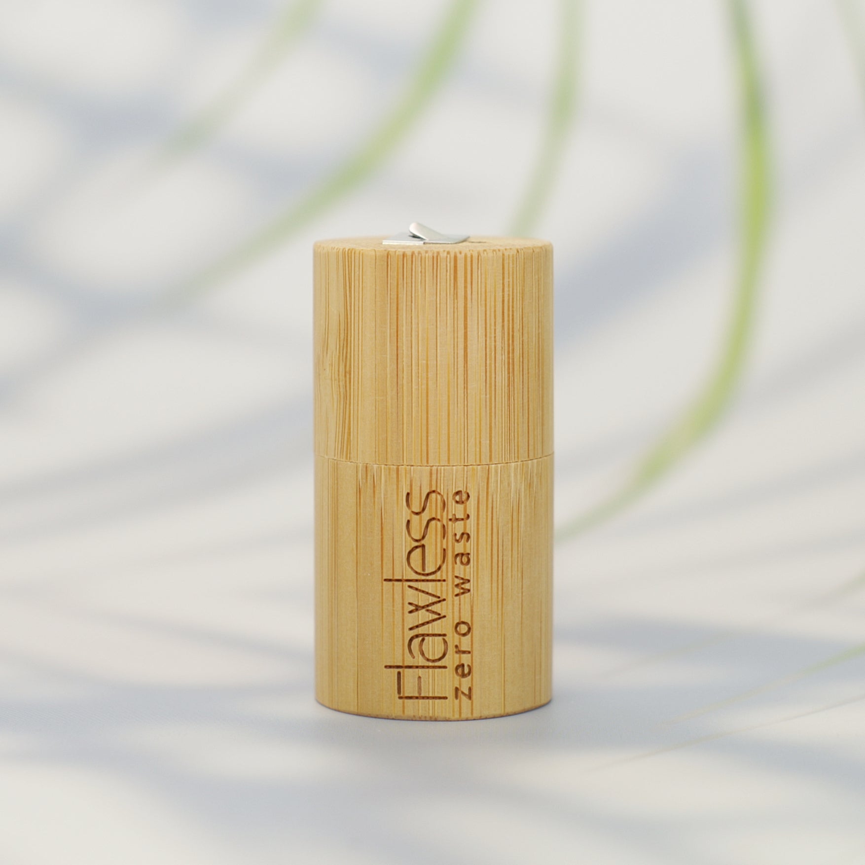 Eco-friendly compostable dental floss in a bamboo dispenser, infused with peppermint oil for fresh breath.