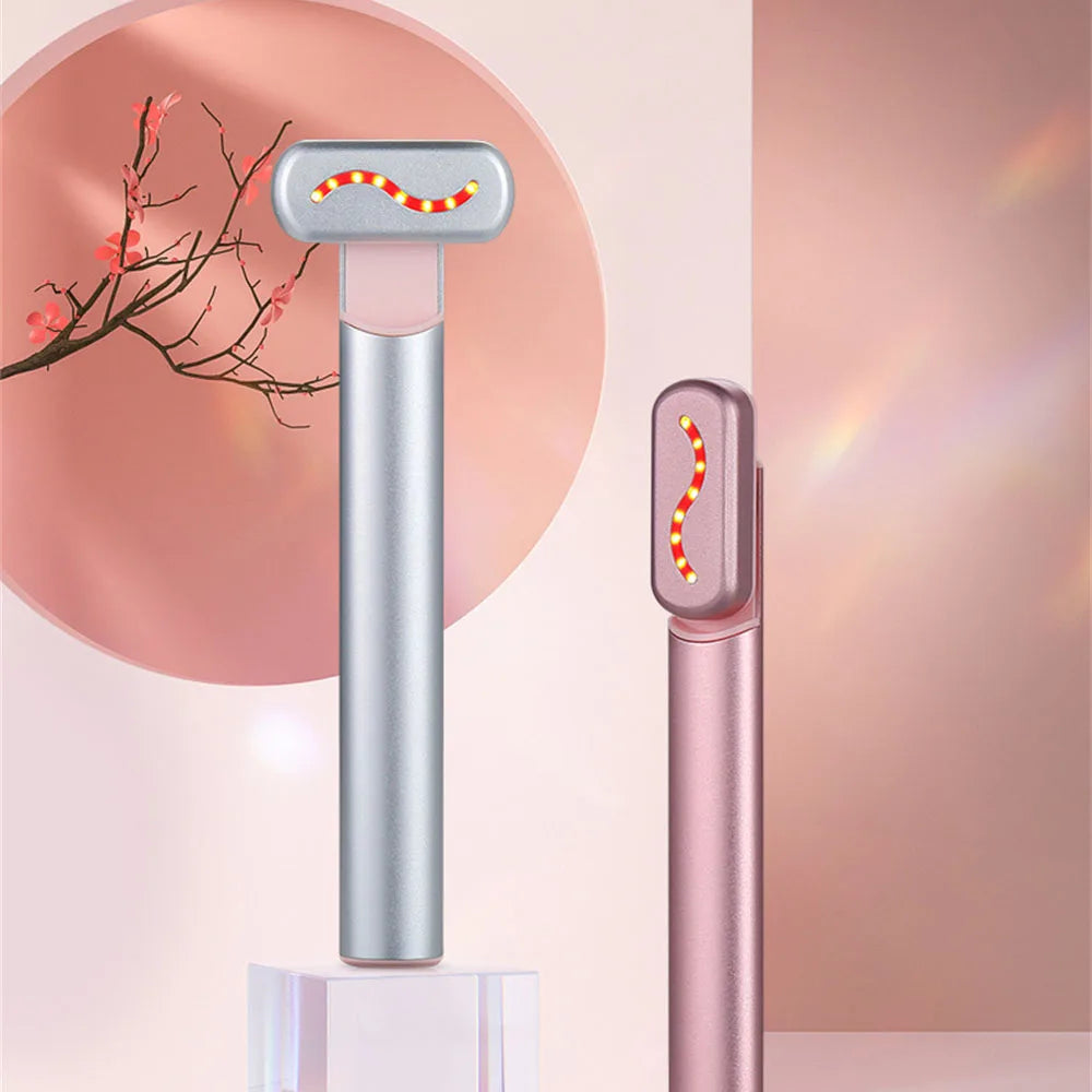 EMS Hot Compress Eye Massager Wand in pink, featuring a rotating metal head and LED lights for rejuvenating eye care.