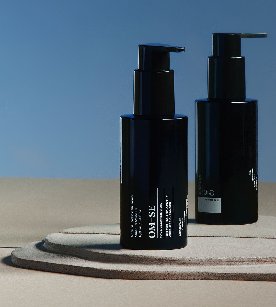 A bottle of Face Cleansing Oil with a dropper, showcasing its rich, golden oil texture, surrounded by organic ingredients.