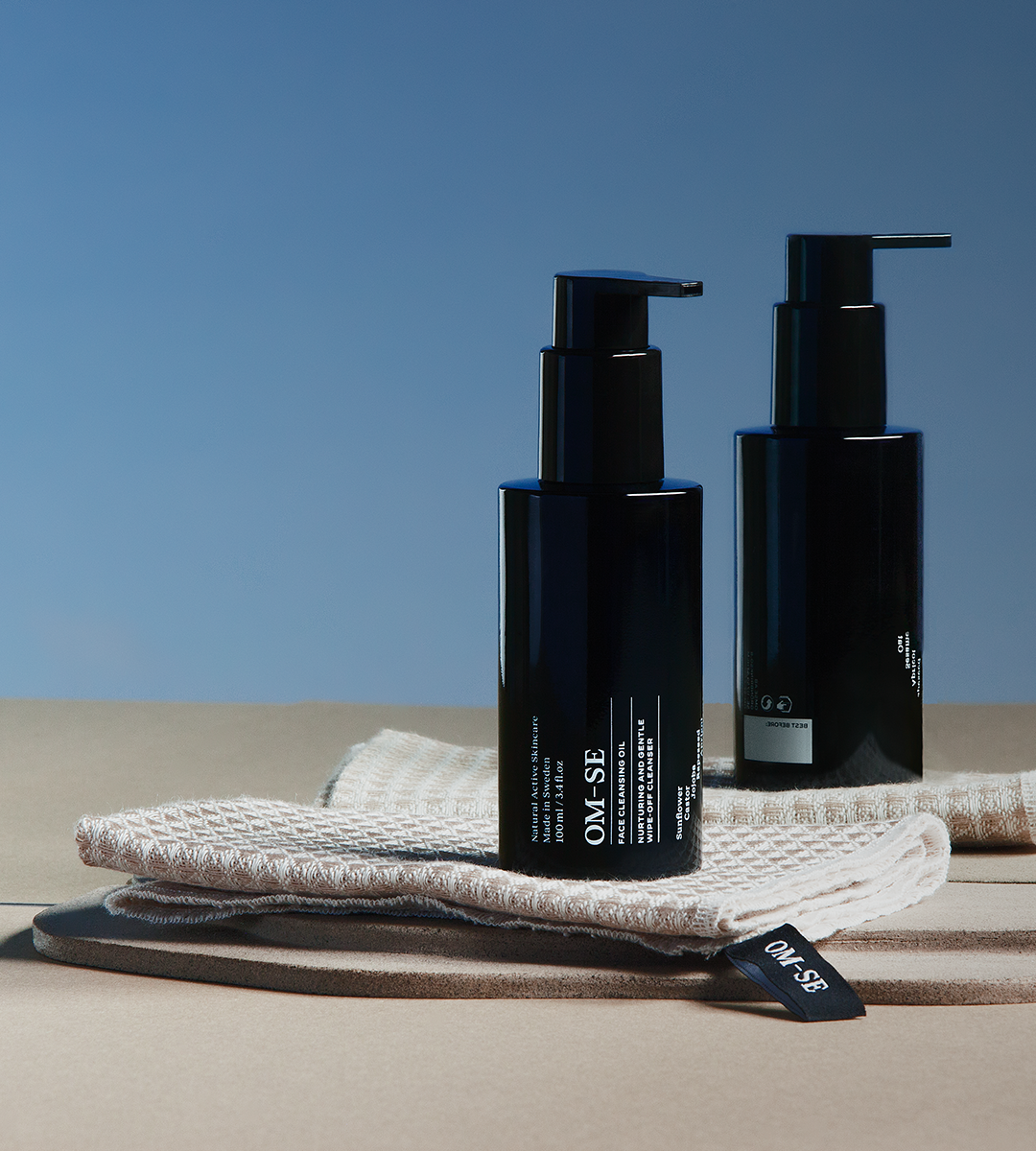 A bottle of Face Cleansing Oil with a dropper, showcasing its rich, golden oil texture, surrounded by organic ingredients.