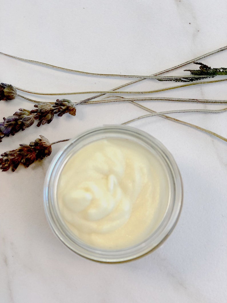 A jar of organic face cream moisturizer with natural ingredients, showcasing its rich texture and eco-friendly packaging.