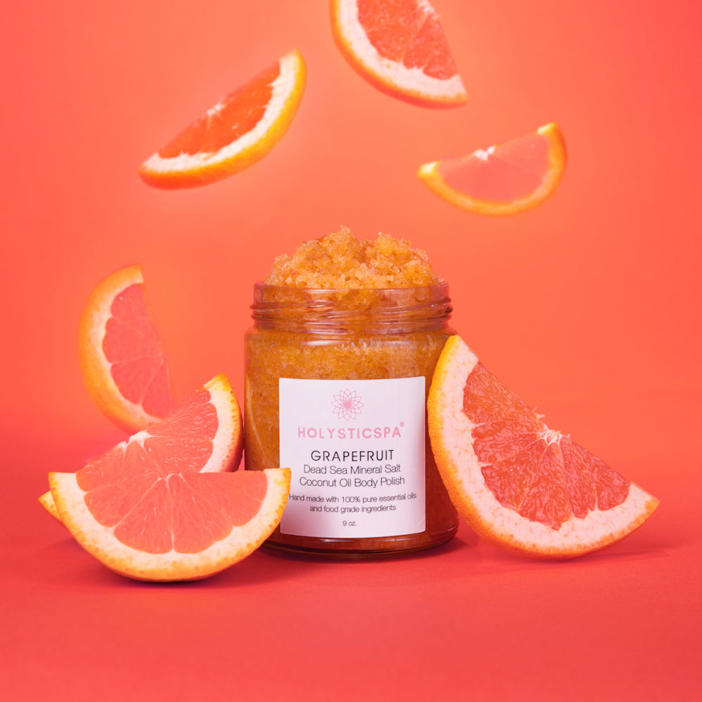 Grapefruit Body Polish in a jar with natural ingredients like Dead Sea salt and coconut oil, showcasing its exfoliating properties.