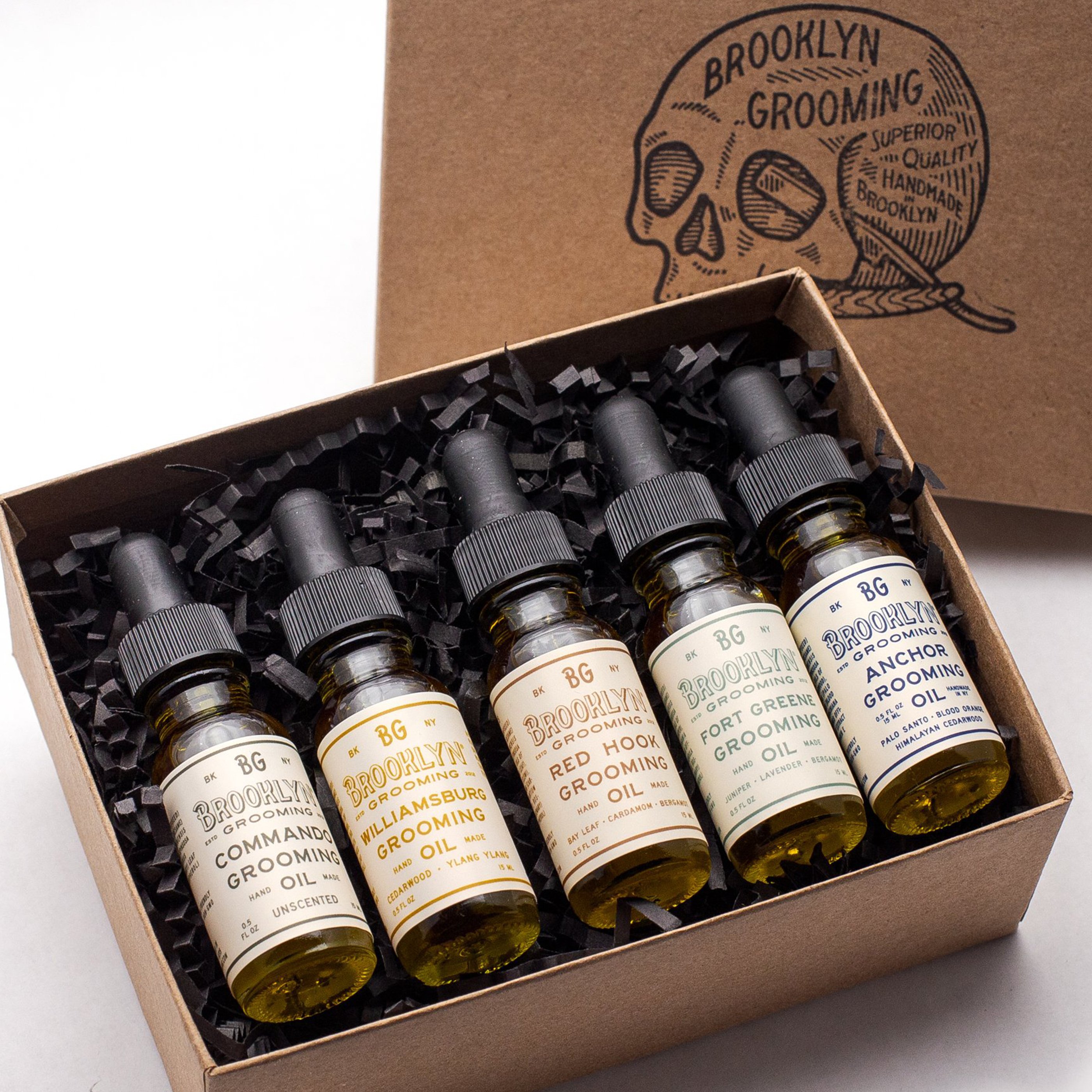 Grooming Oil Sampler Kit featuring five travel-sized dropper bottles in a hand-stamped gift box with a postcard.