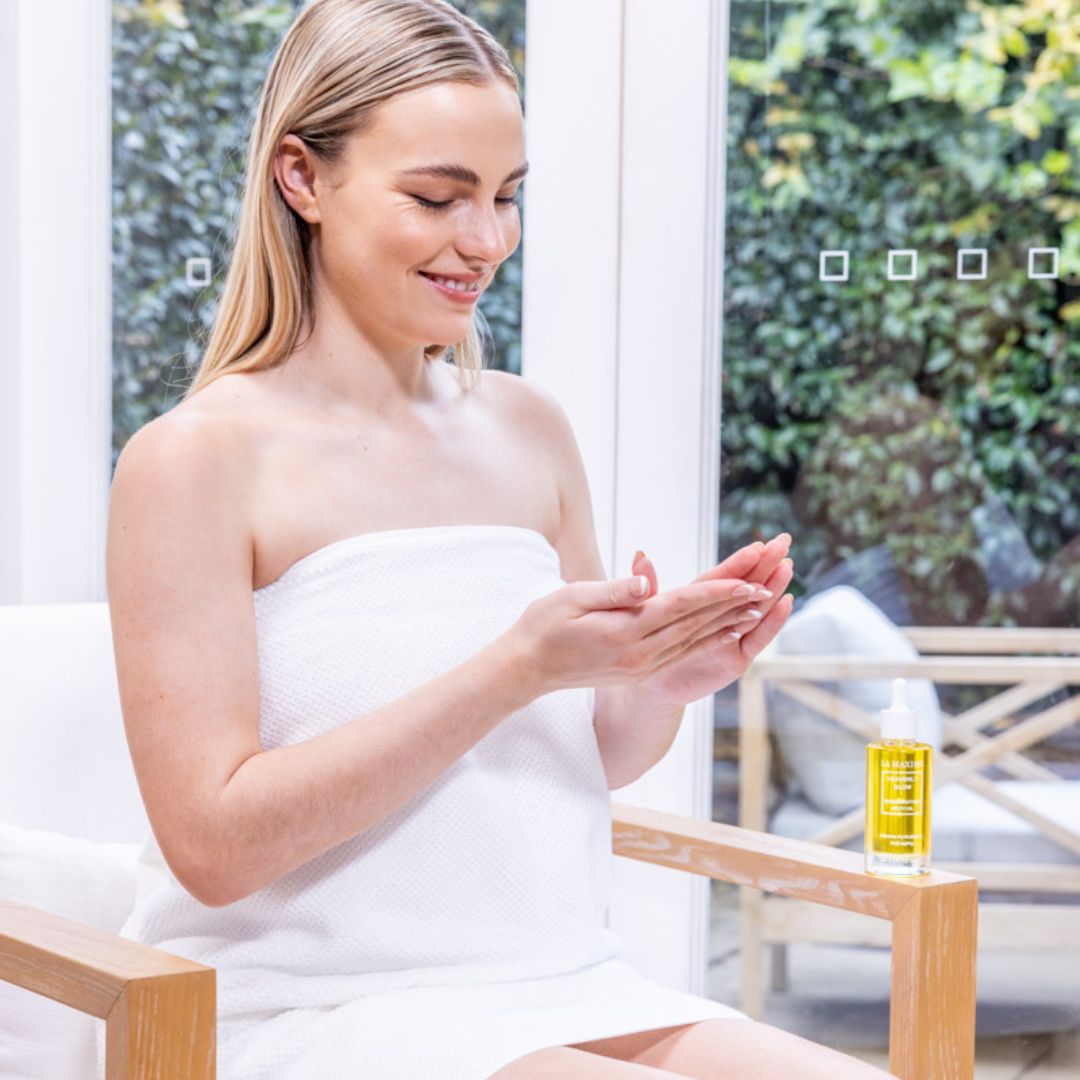 La Maxime Heavenly Glow Regenerating Body Oil bottle with a sleek design, showcasing its nourishing properties for dry skin.