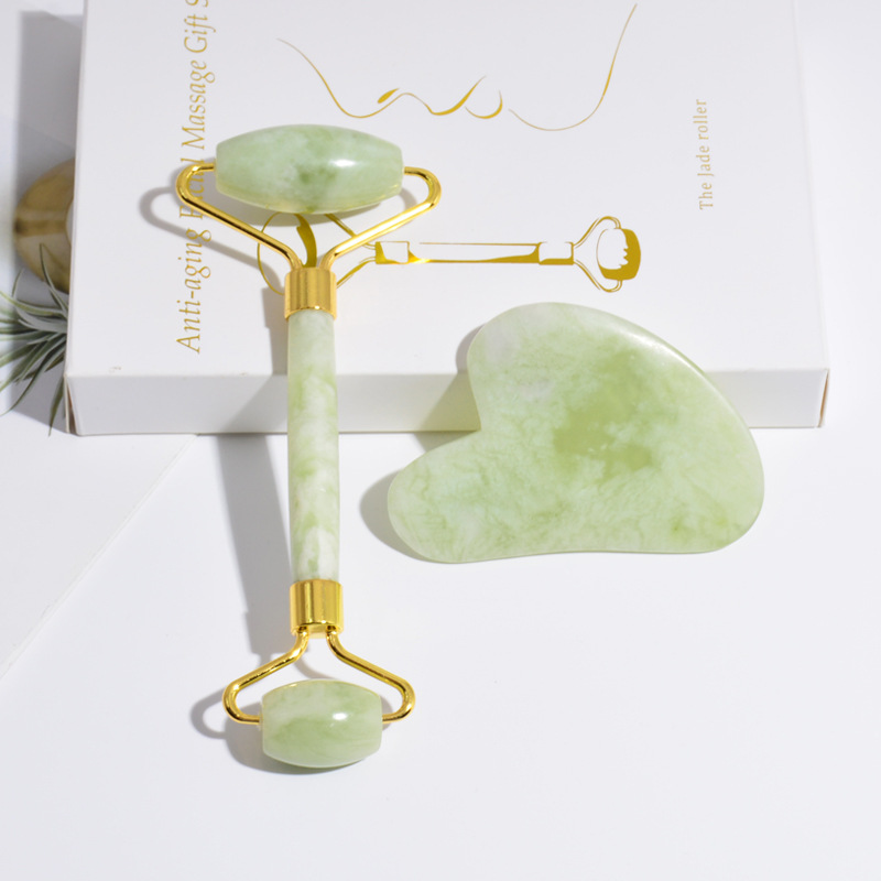 Jade Roller and Gua Sha tools elegantly displayed in a gift box, showcasing their natural jade material and beauty.