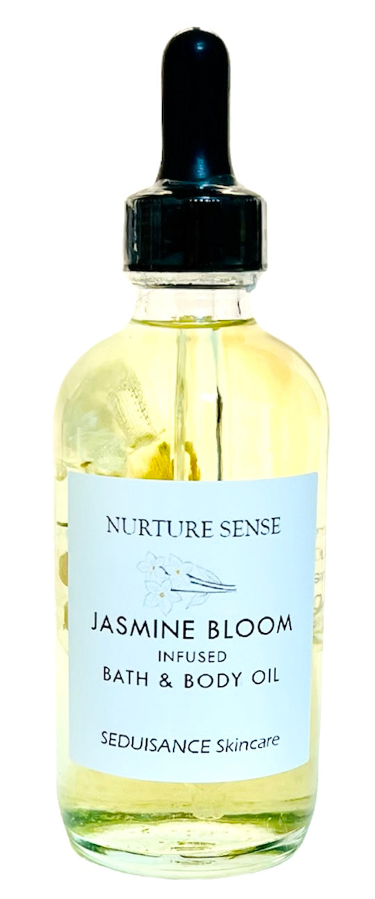 Jasmine Bloom Infused Bath & Body Oil in a glass bottle with jasmine flowers and essential oils, showcasing its natural ingredients.