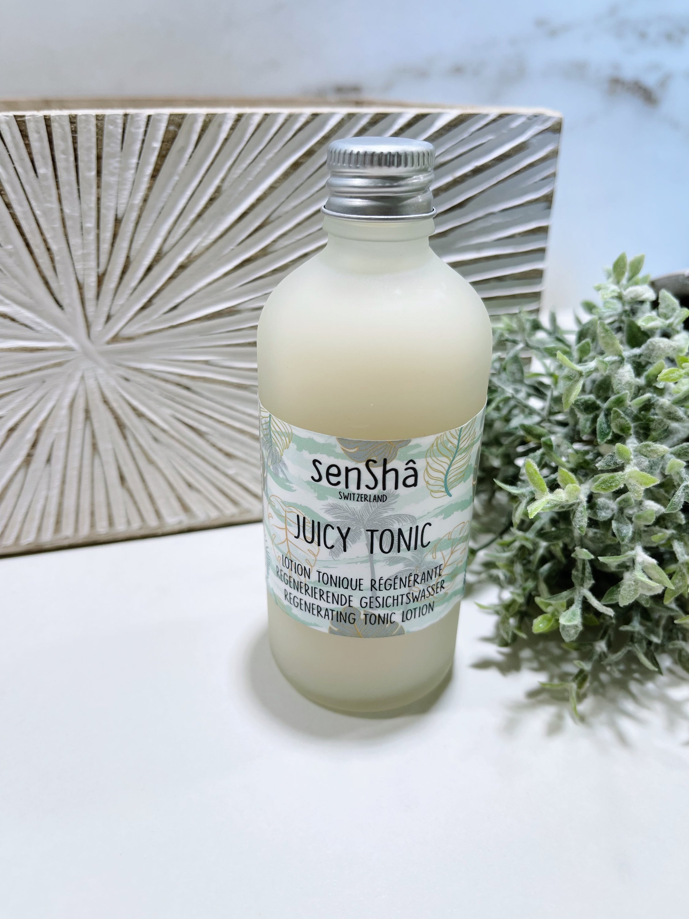 Juicy Tonic 100ml bottle with a refreshing design, showcasing its hydrating properties and natural ingredients.