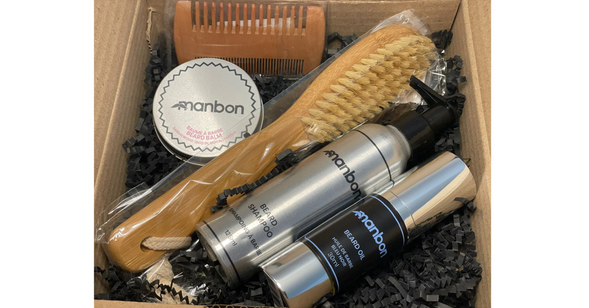 Manbon Natural and Luxurious Beard Growth & Grooming Kit featuring shampoo, oil, balm, and brush in an elegant packaging.