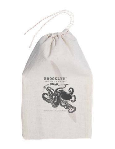 Men's Handmade Mustache and Beard Comb with custom engraving and rounded tips, displayed in a hand stamped muslin bag.