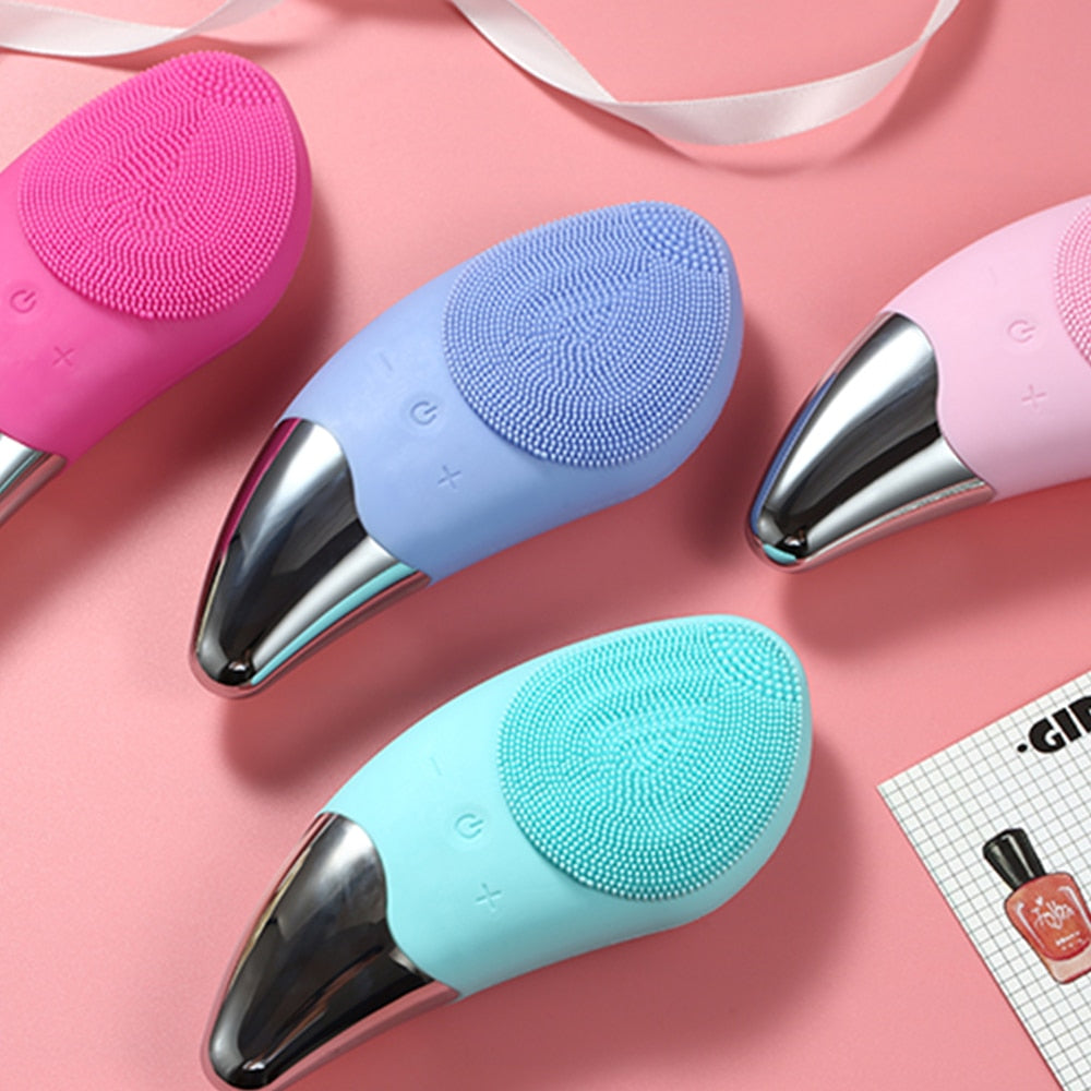 Mini Electric Facial Cleansing Brush in pink color with silicone bristles, designed for deep pore cleansing and facial massage.