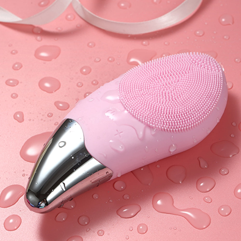 Mini Electric Facial Cleansing Brush in pink color with silicone bristles, designed for deep pore cleansing and facial massage.