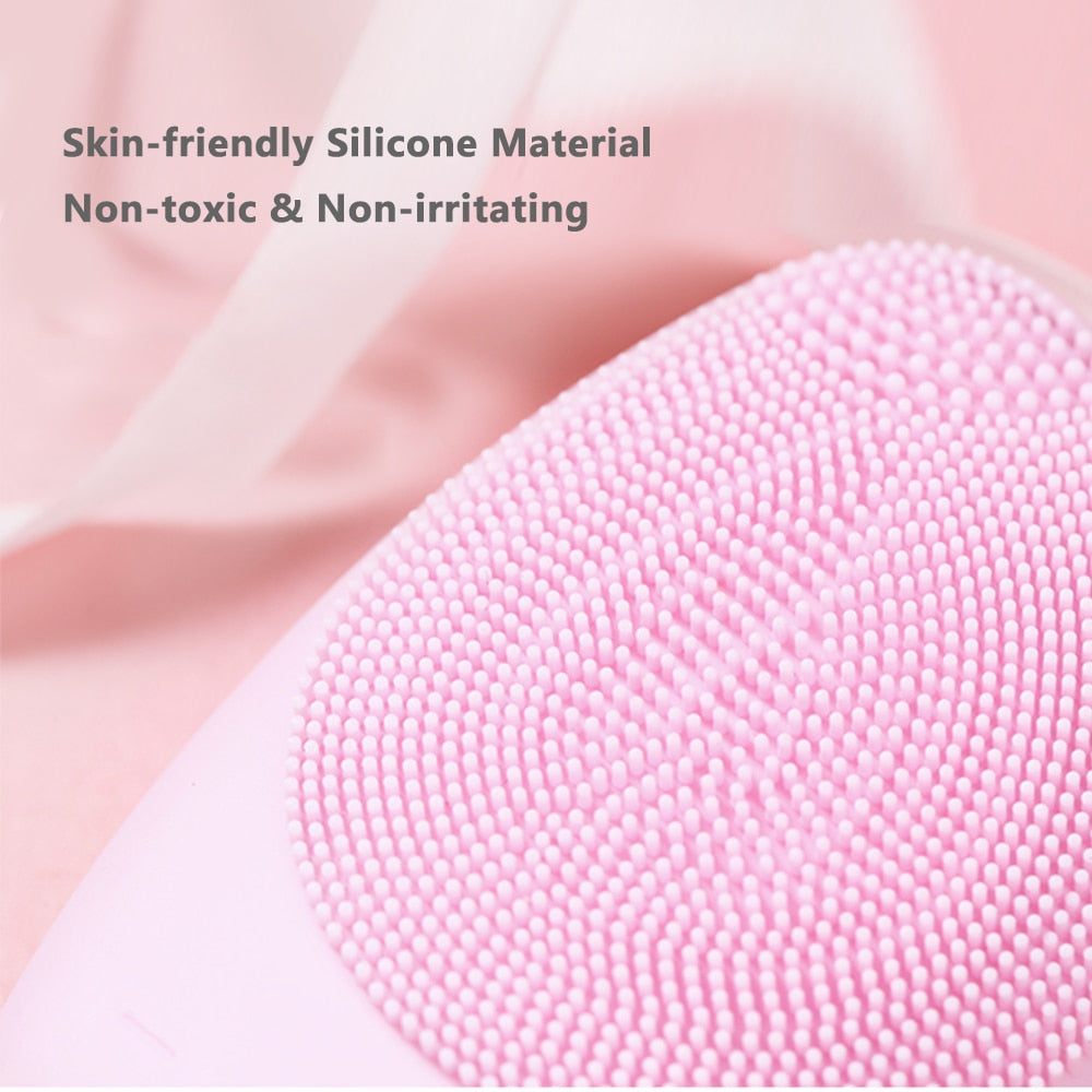 Mini Electric Facial Cleansing Brush in pink color with silicone bristles, designed for deep pore cleansing and facial massage.