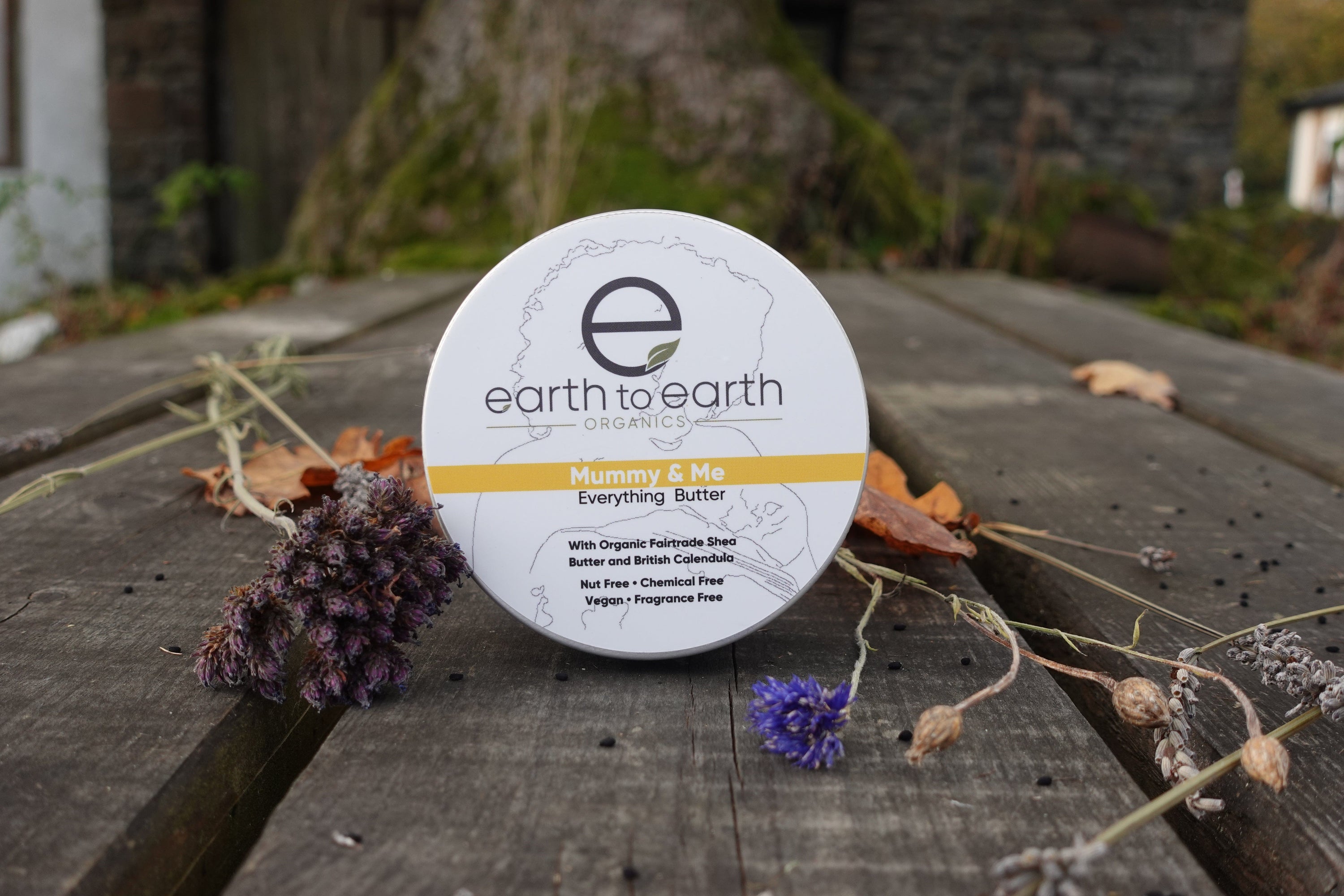 A jar of Mother and Baby Body Butter, showcasing its light yellow color and creamy texture, perfect for nourishing skin.