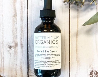 A bottle of Organic Facial Serum featuring a blend of natural oils for anti-aging and wrinkle reduction, set against a soft, neutral background.
