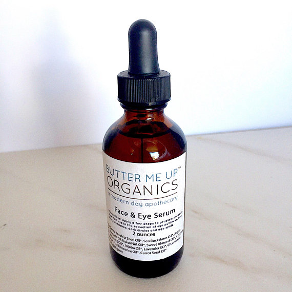 A bottle of Organic Facial Serum featuring a blend of natural oils for anti-aging and wrinkle reduction, set against a soft, neutral background.