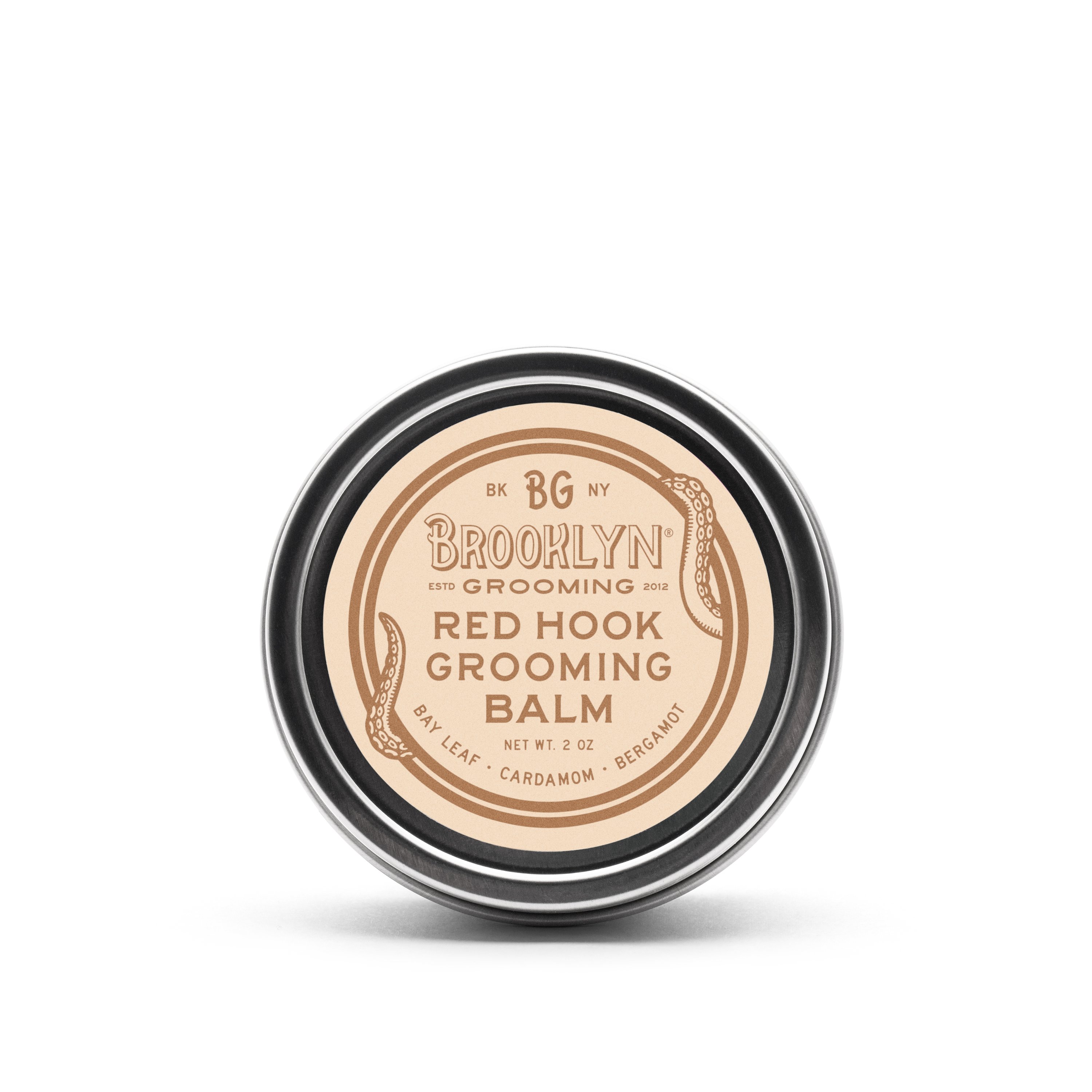 Red Hook Grooming Balm in a seamless aluminum tin, showcasing its natural ingredients and spiced bay scent.