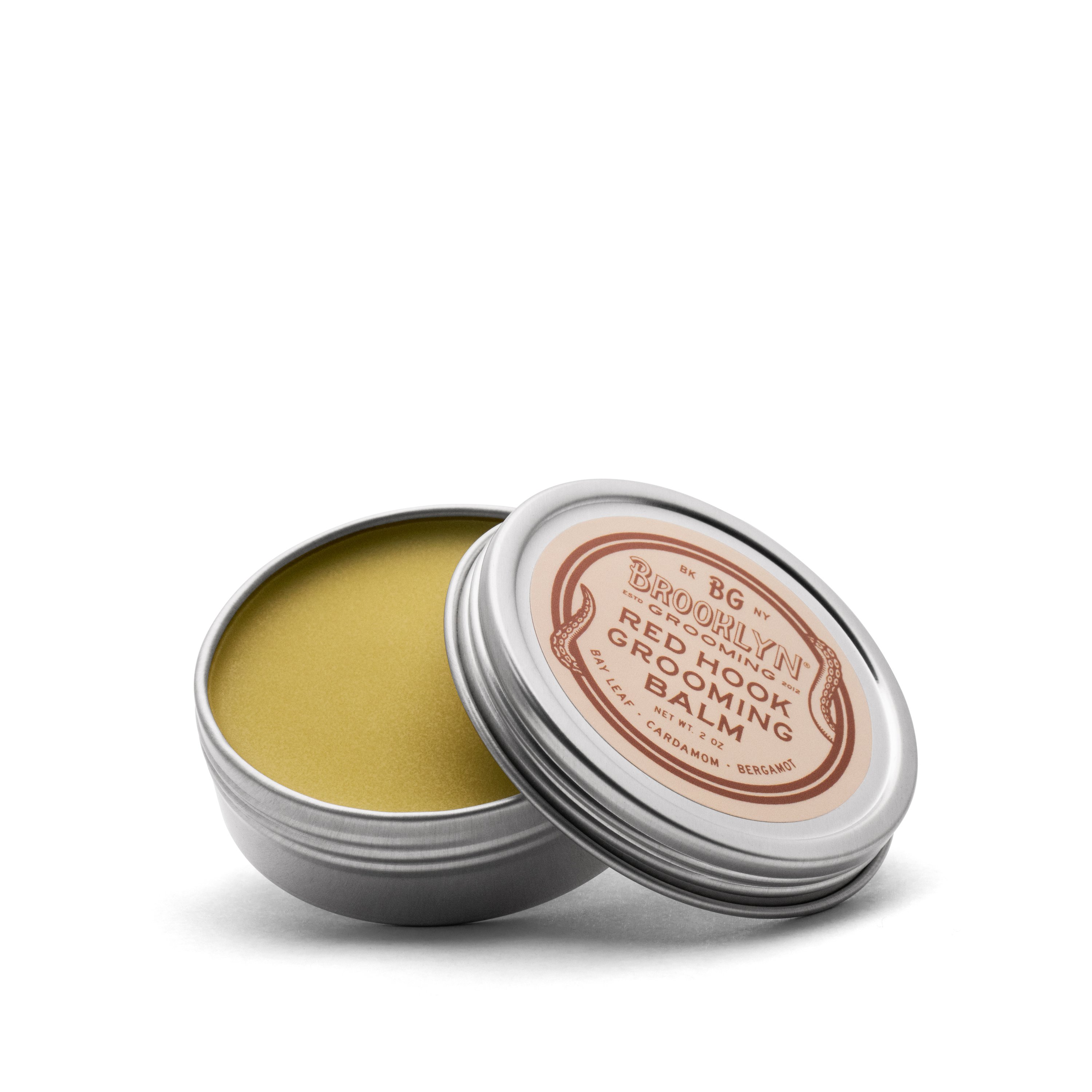 Red Hook Grooming Balm in a seamless aluminum tin, showcasing its natural ingredients and spiced bay scent.