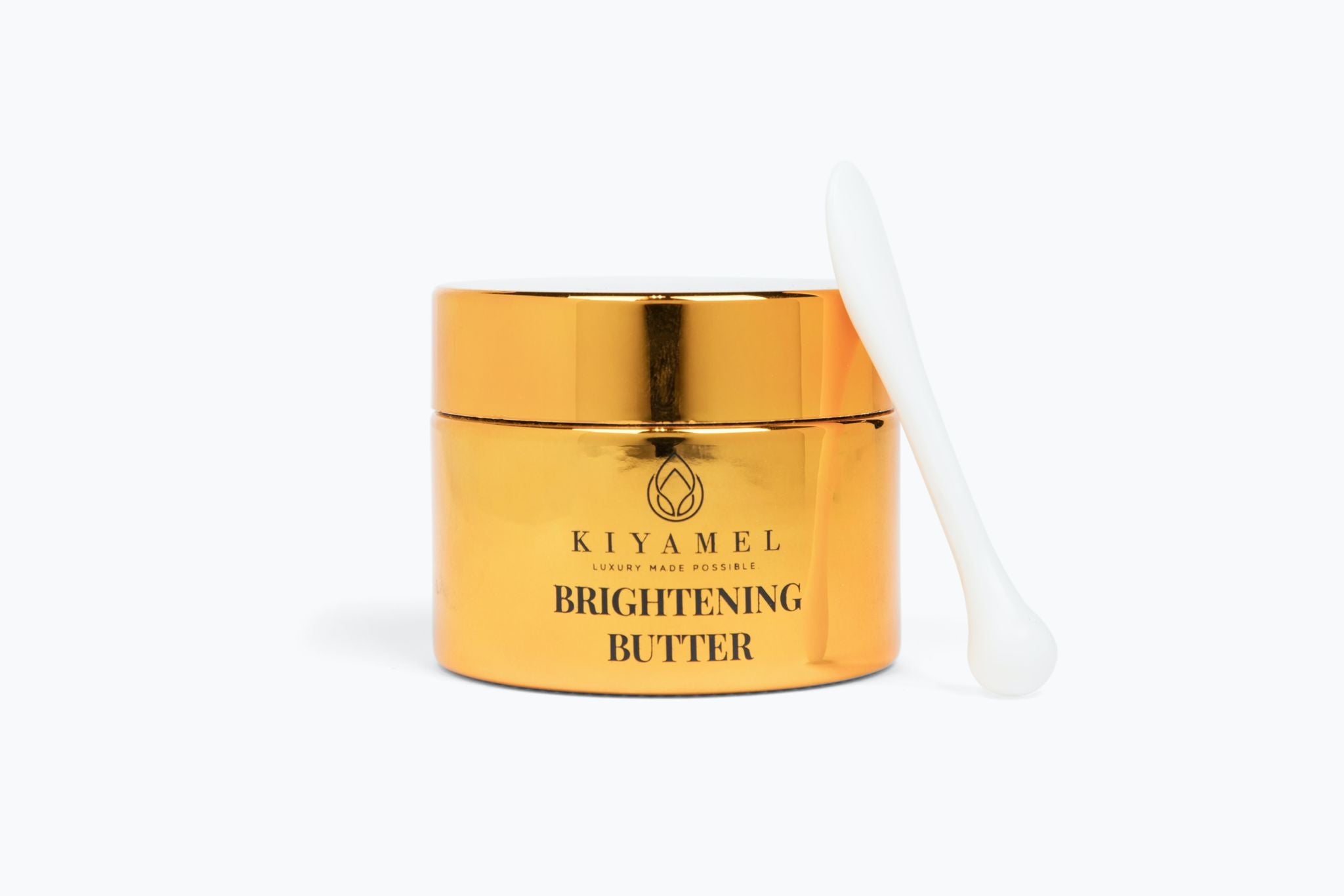 A jar of Revolutionary Brightening Butter with a creamy texture, surrounded by natural ingredients like rosehip oil and shea butter.