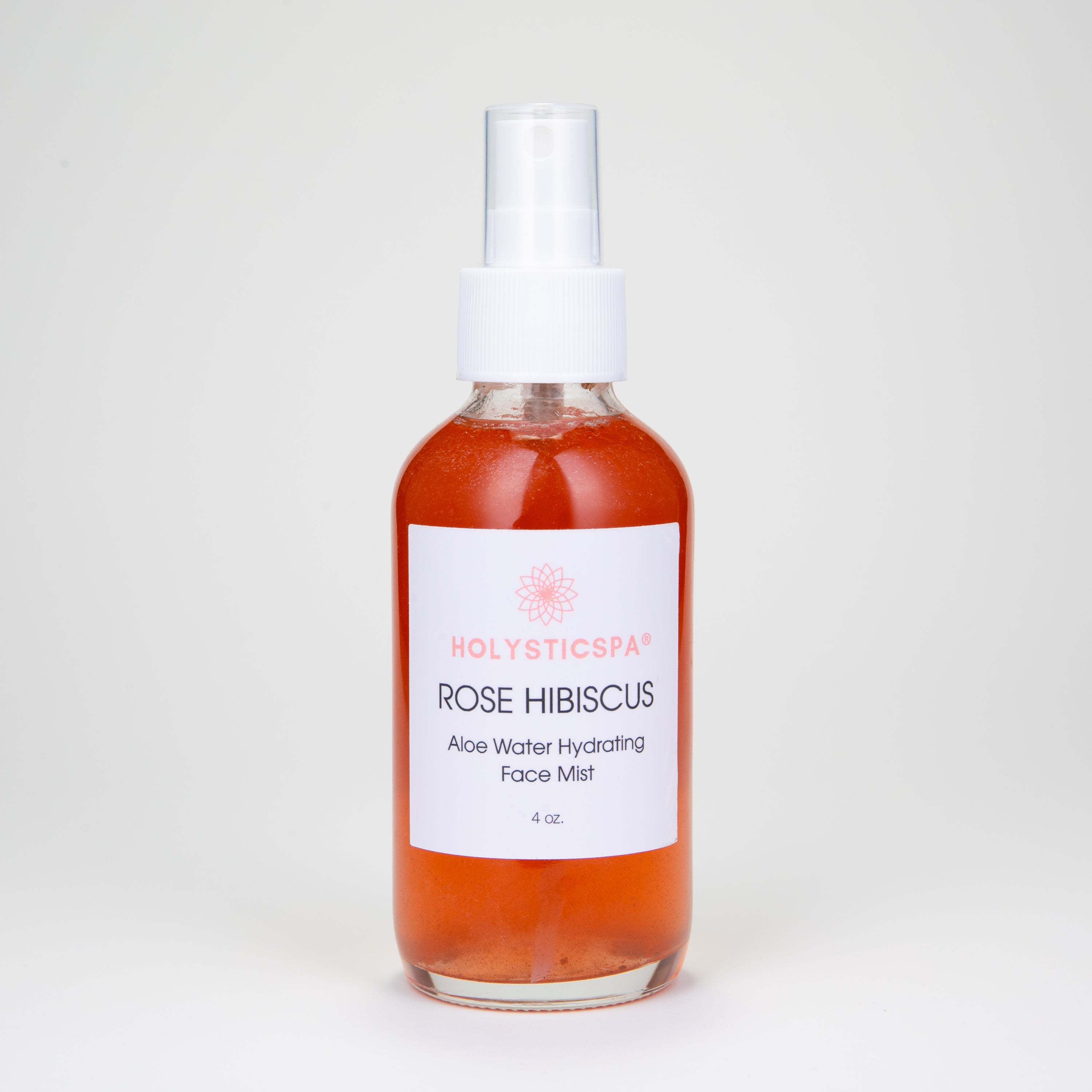 A bottle of Rose Hibiscus Aloe Water Hydrating Face Mist with floral design, showcasing its hydrating properties.
