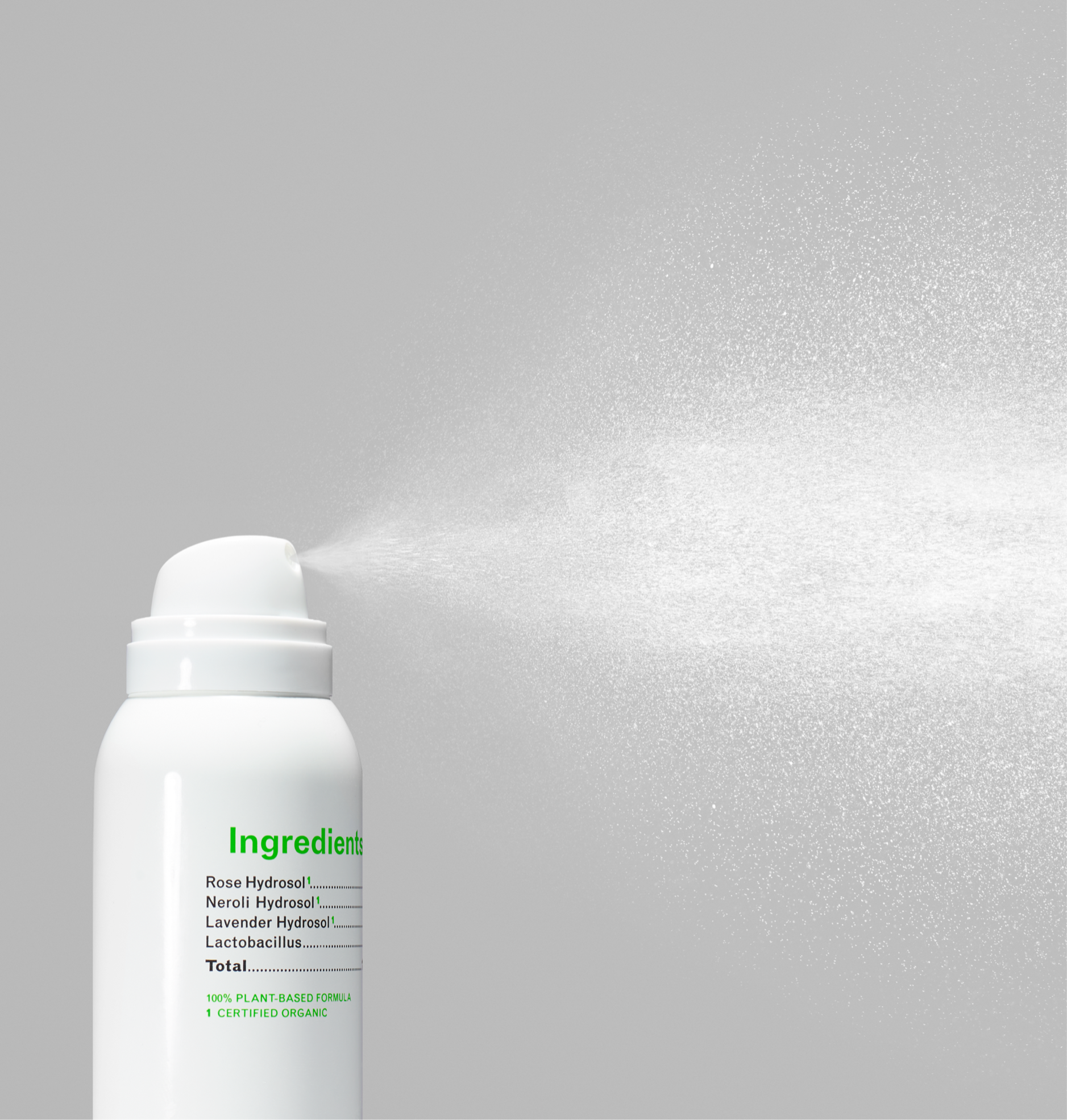 A bottle of Rose Plant Water Mist featuring a blend of organic hydrosols, surrounded by fresh roses and lavender flowers.