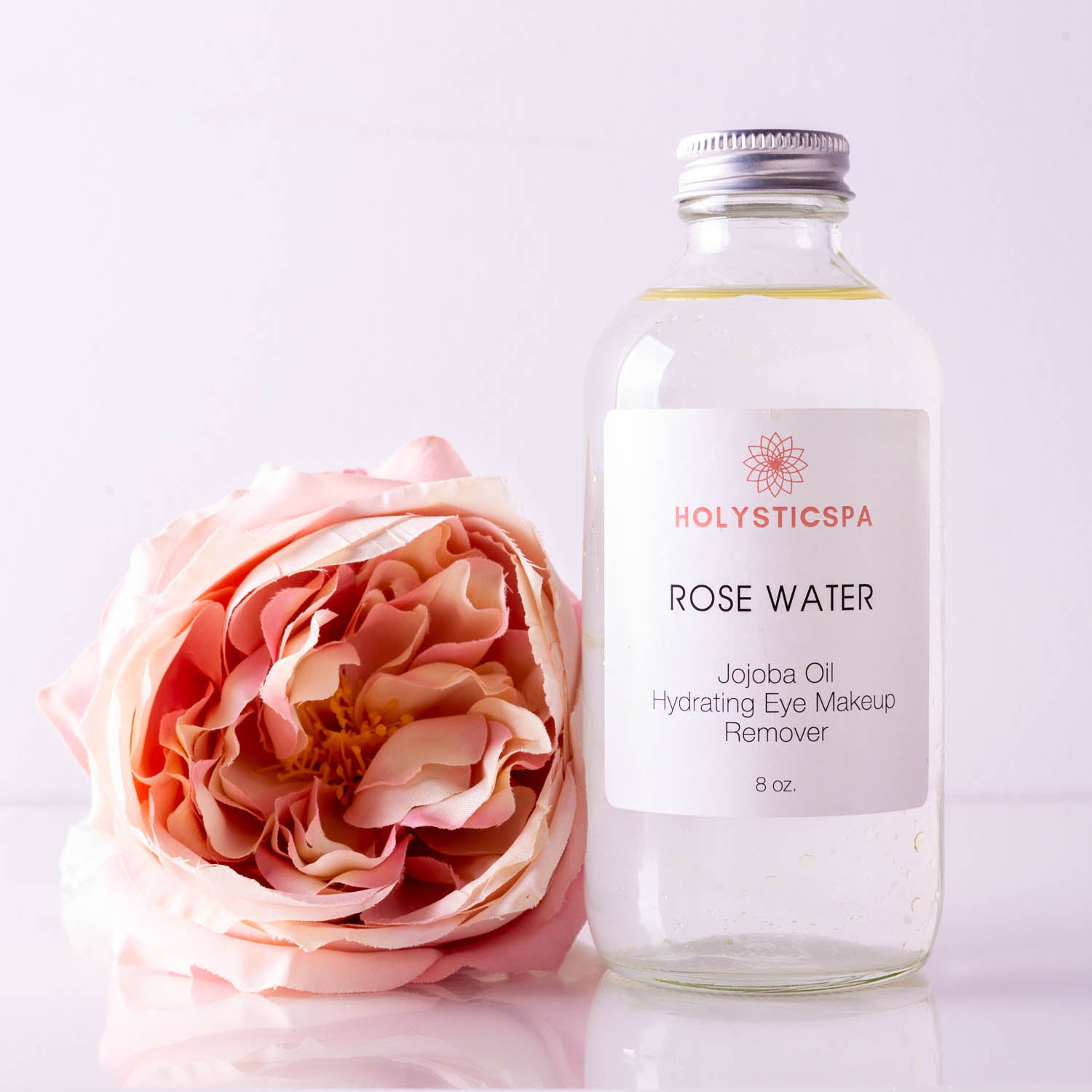 A bottle of Rose Water Hydrating Makeup Remover with a floral design, showcasing its natural ingredients and gentle formula.