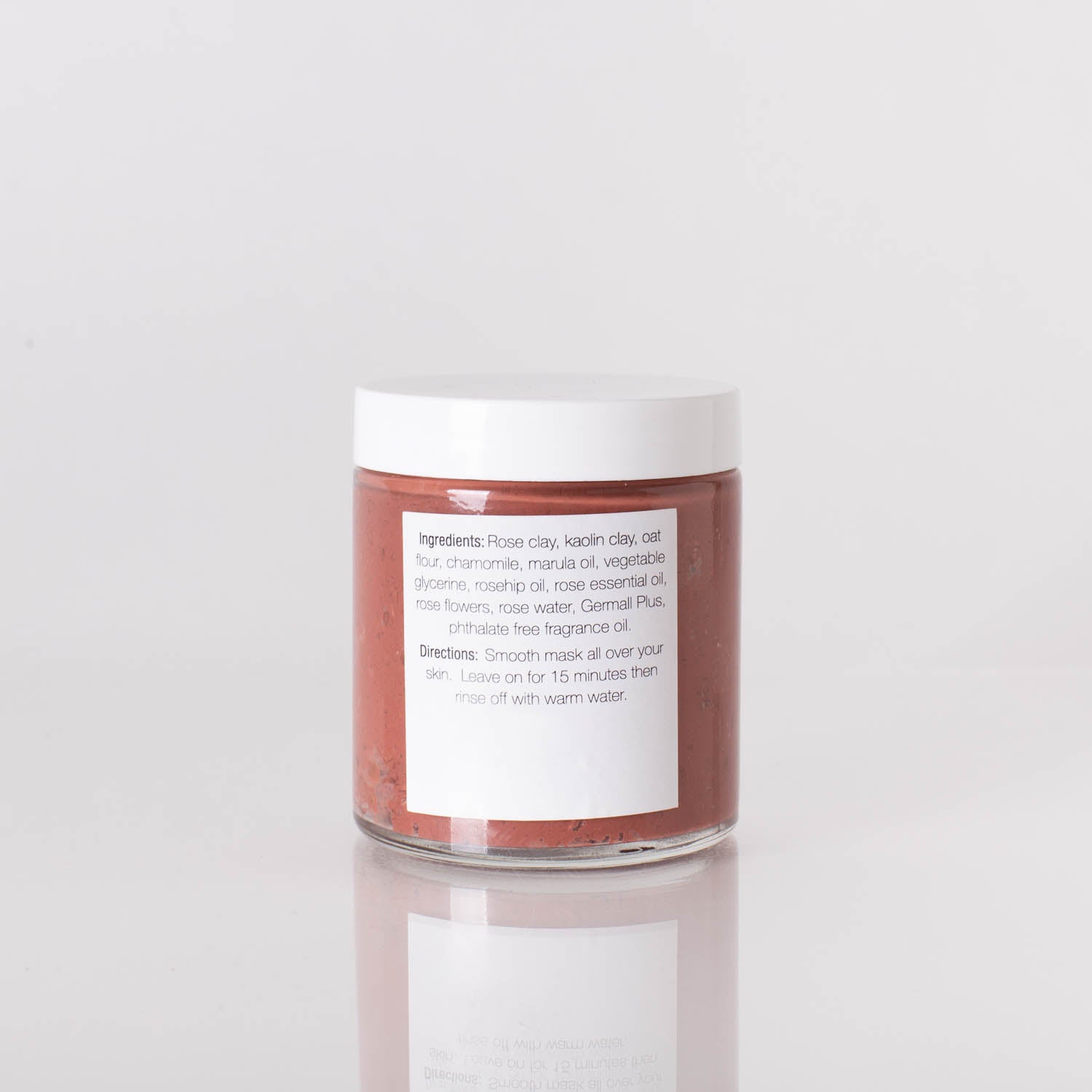 Rosy Days Hydrating Face Mask with rose and kaolin clay in a jar, surrounded by rose petals.