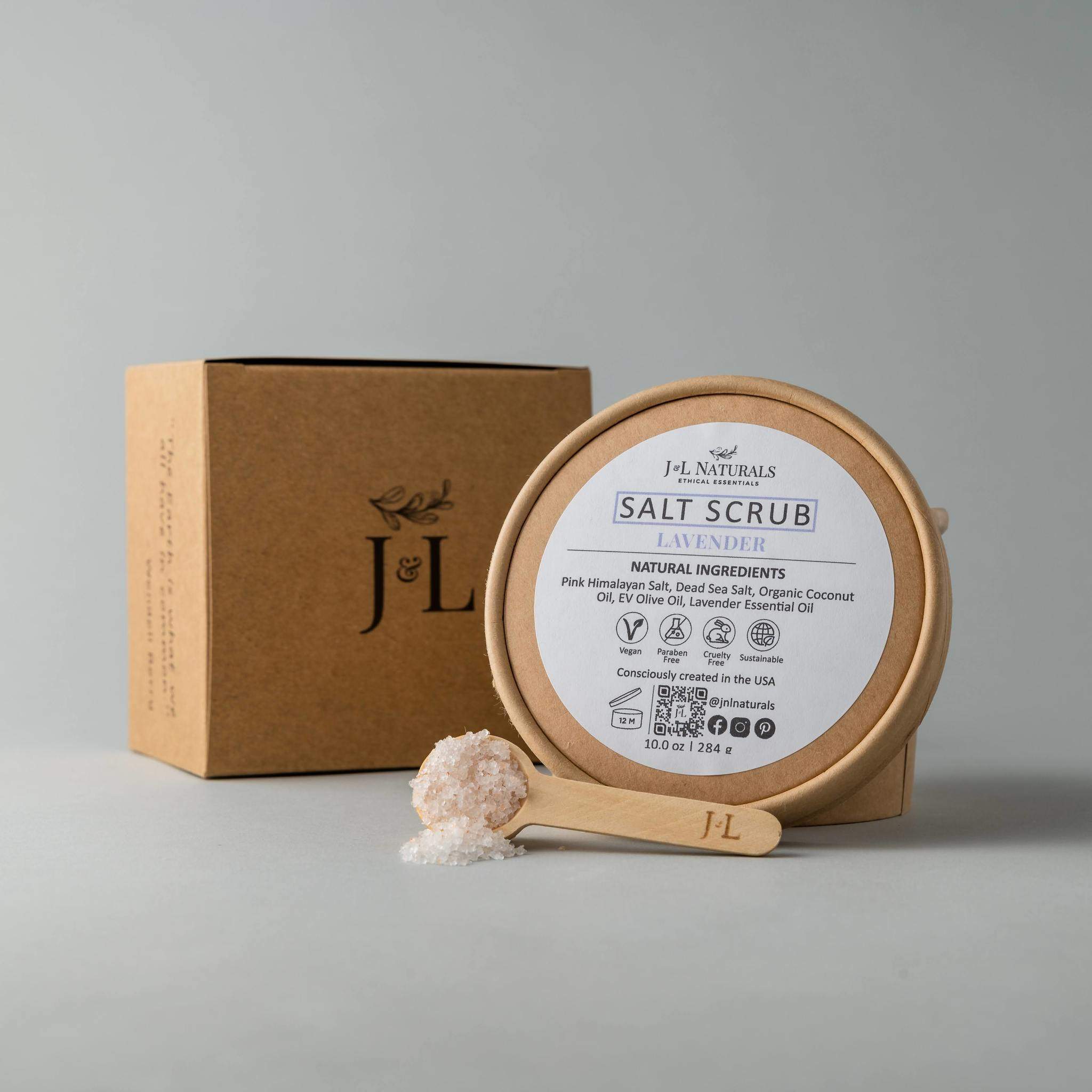 A jar of Salt Scrub featuring pink Himalayan salt and dead sea salt, with a scoop beside it, showcasing its natural exfoliating ingredients.