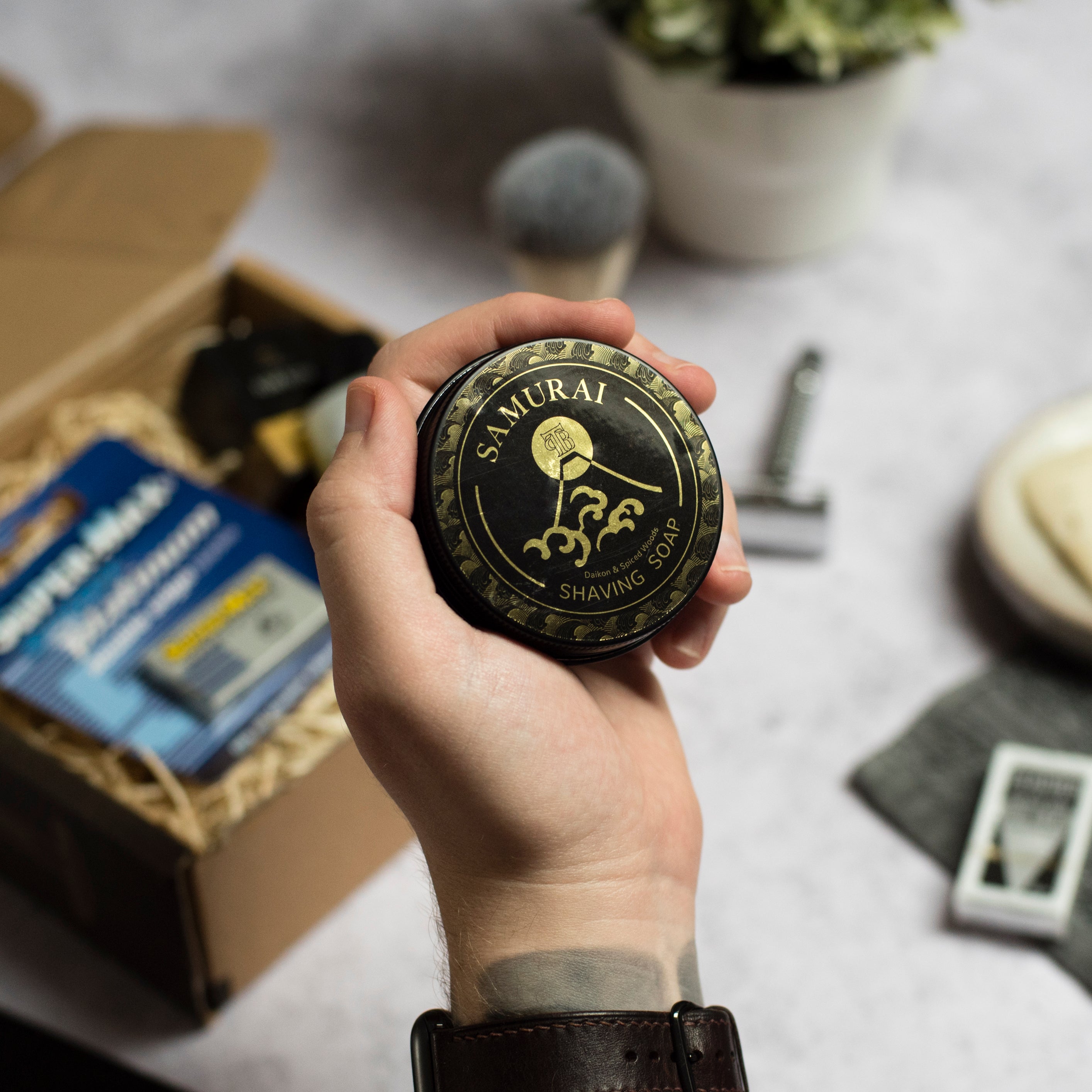 A tin of Samurai Shaving Soap featuring a rich, creamy texture and vibrant packaging, ideal for a luxurious shaving experience.