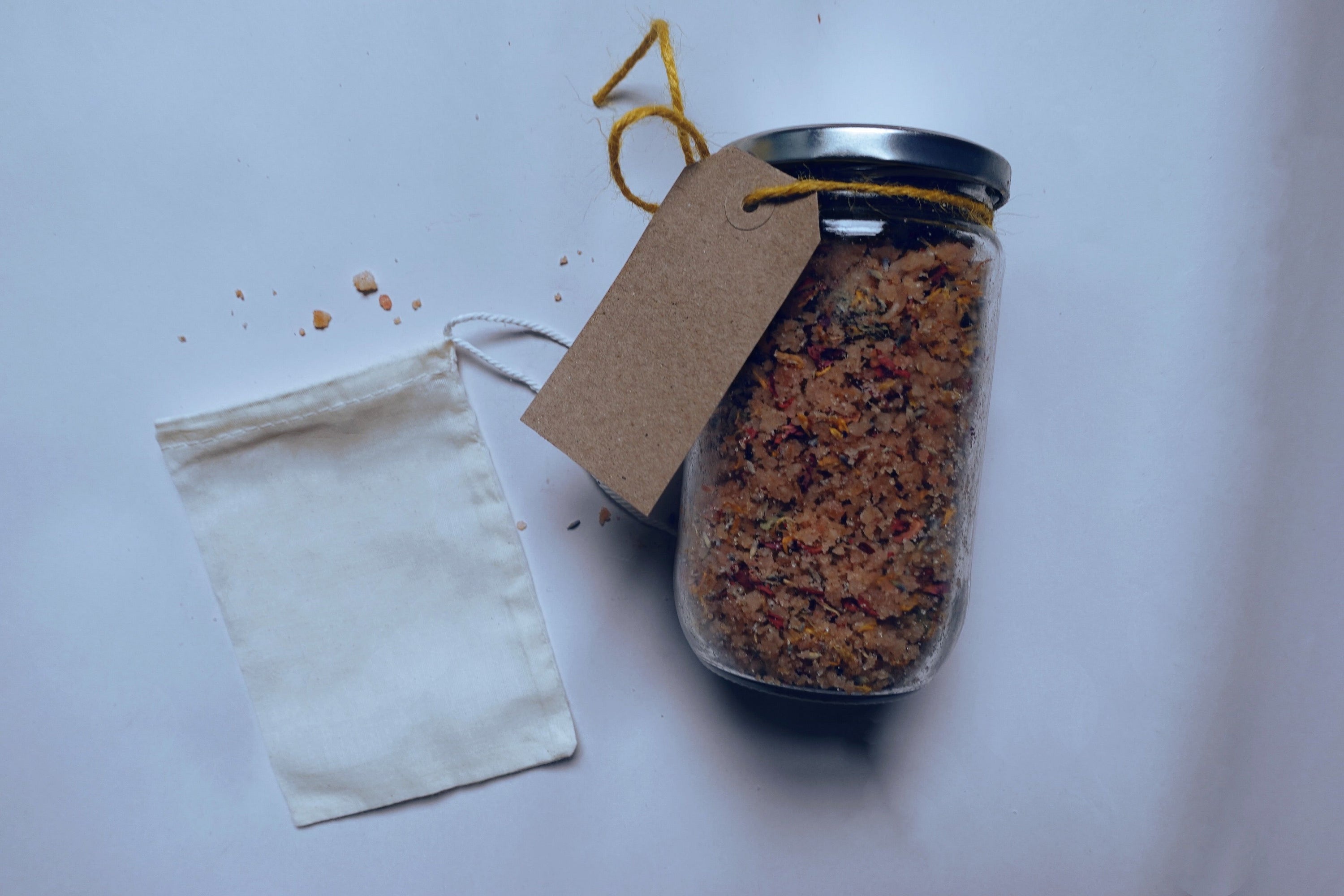 A 500g package of Soothing Bath Soak Salts with Baobab Oil, featuring lavender and rose petals, designed for a relaxing bath experience.