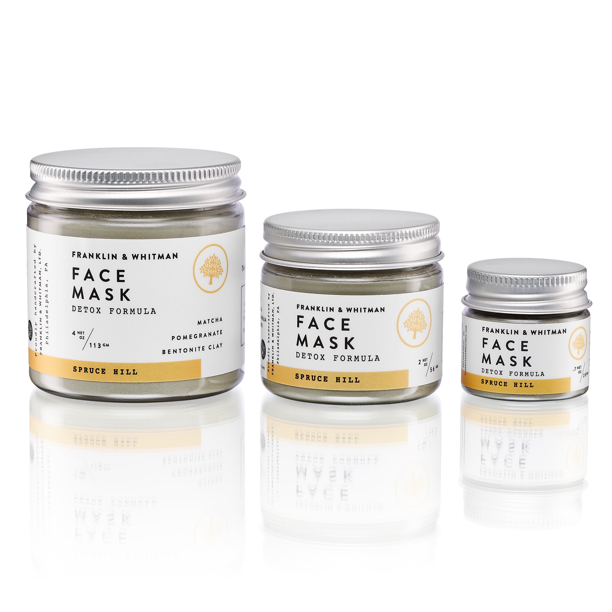 Spruce Hill Clay Mask in a jar with a wooden spoon, showcasing its powdery texture and natural ingredients.
