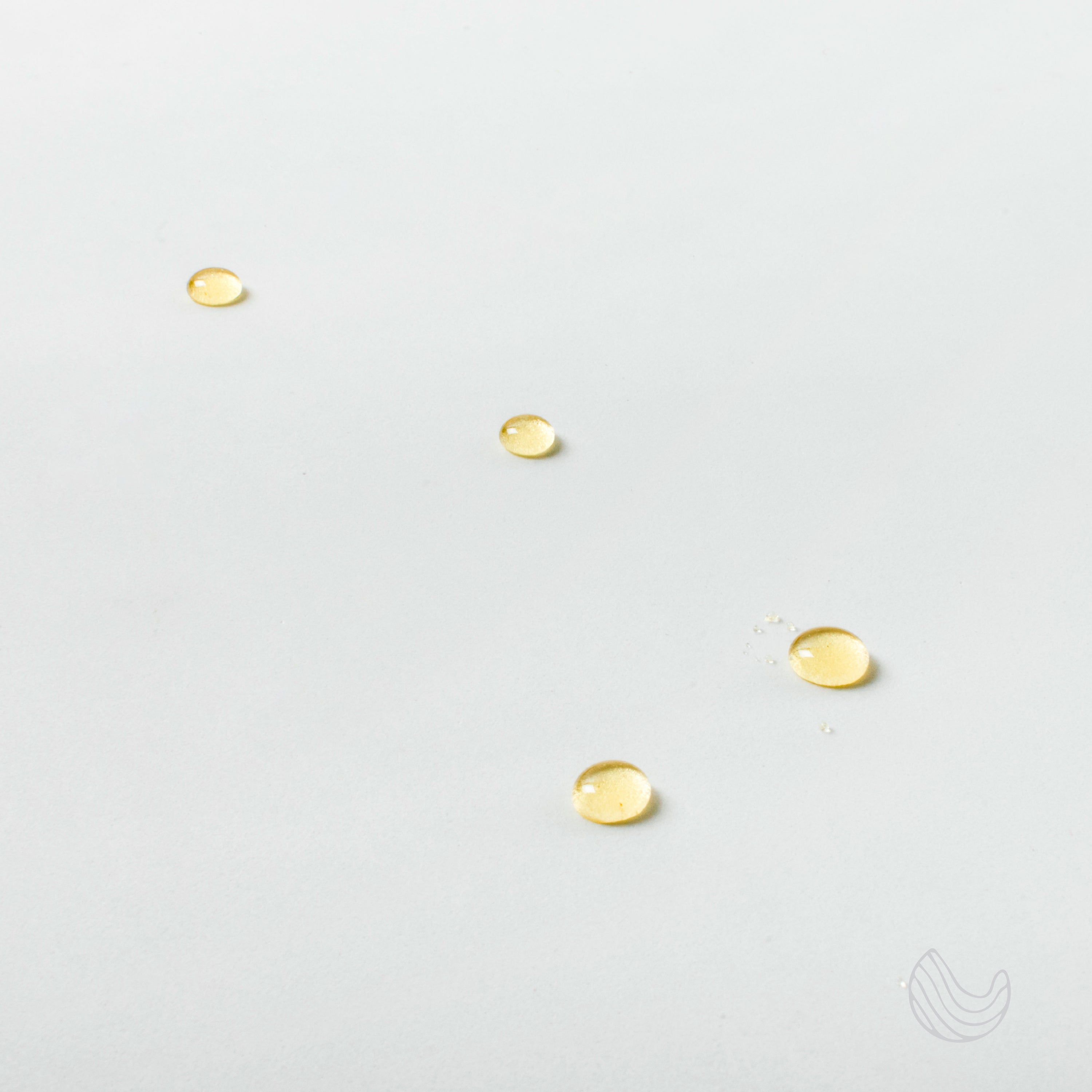 A bottle of Sweet Dreams Essential Oil Blend featuring eucalyptus and lavender, surrounded by calming elements like stones and flowers.