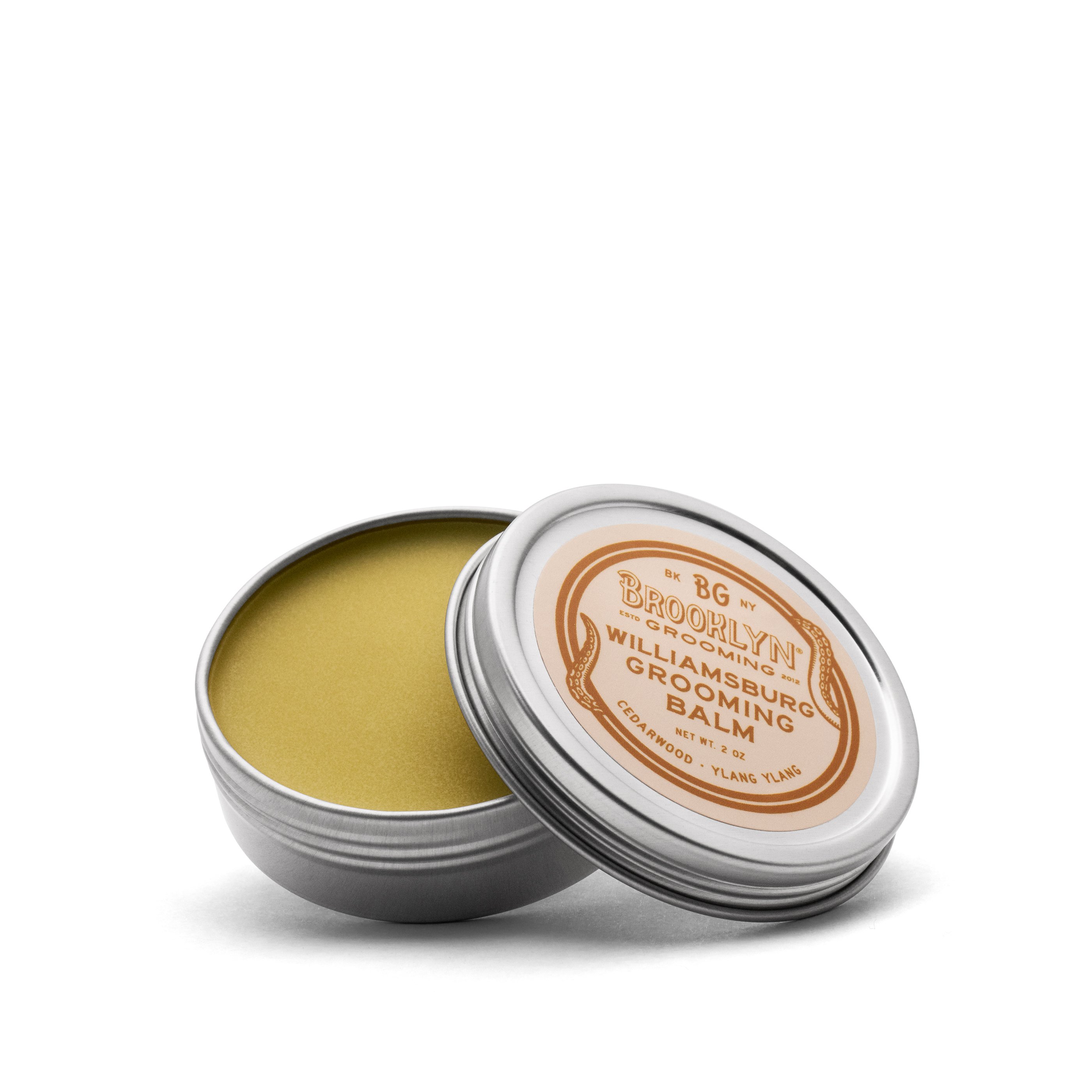 Williamsburg Grooming Balm in a sleek aluminum tin, showcasing its natural ingredients and woodsy scent.