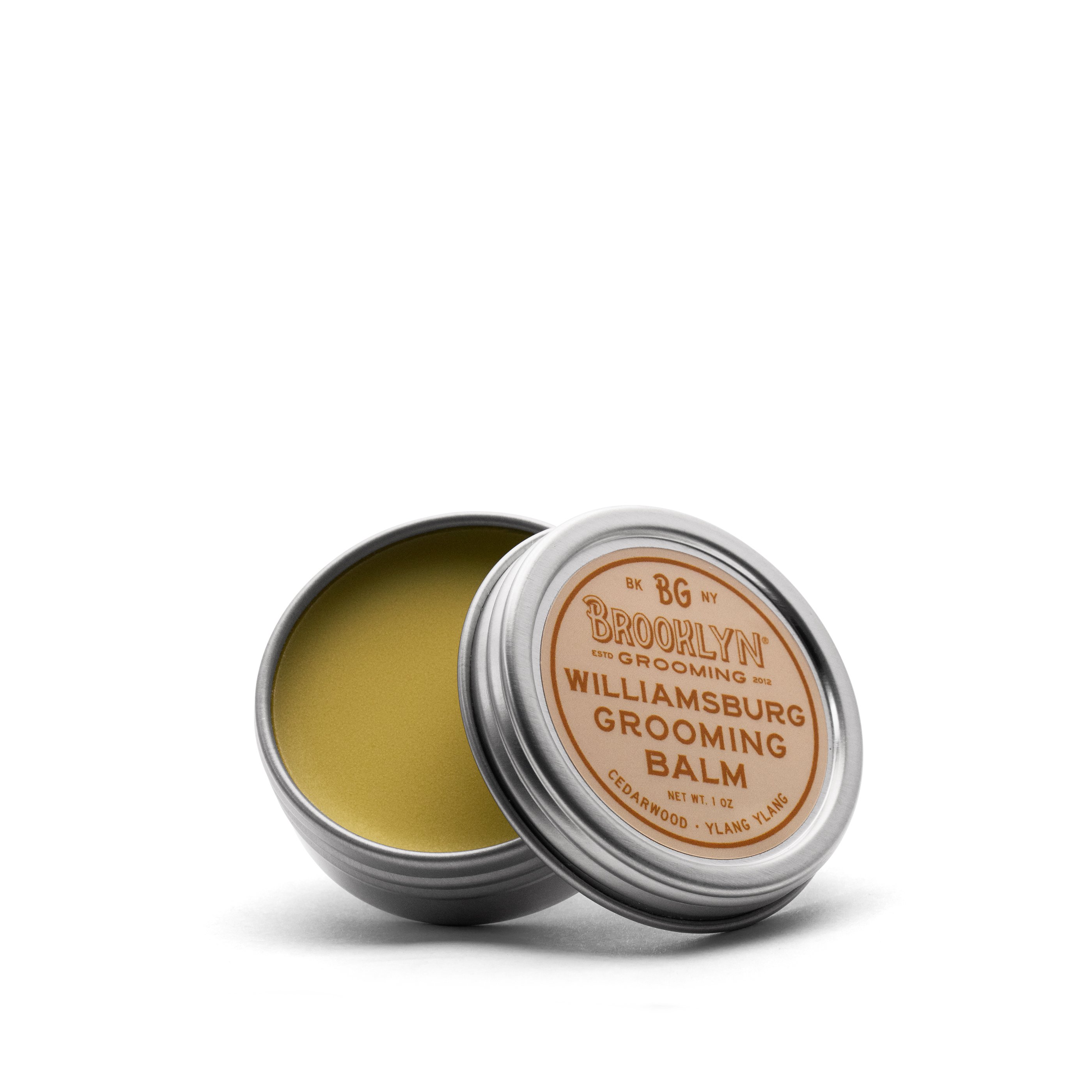 Williamsburg Grooming Balm in a sleek aluminum tin, showcasing its natural ingredients and woodsy scent.