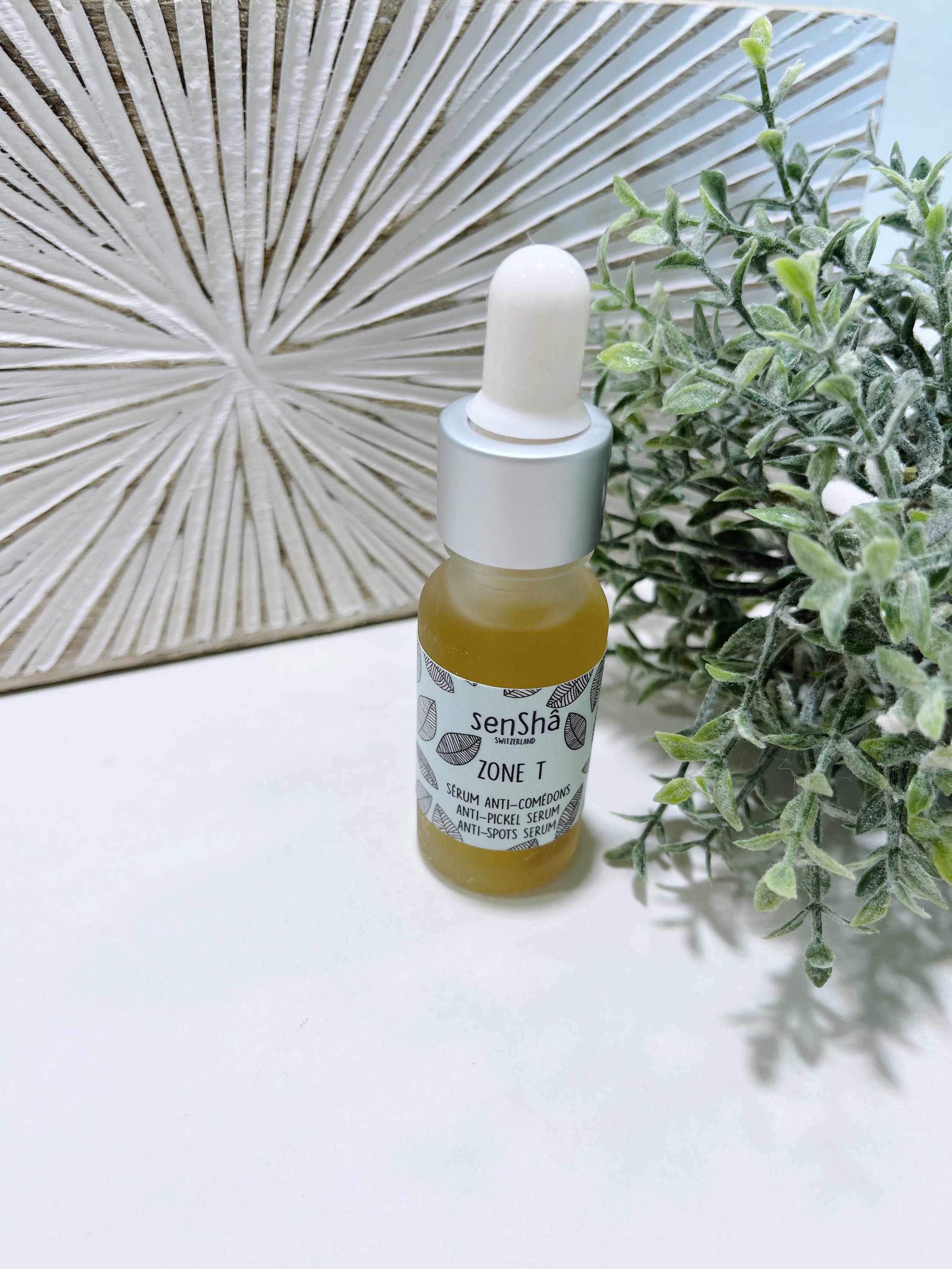 Zone-T 15ml anti-imperfection serum bottle with a dropper, showcasing its sleek design and natural ingredients.