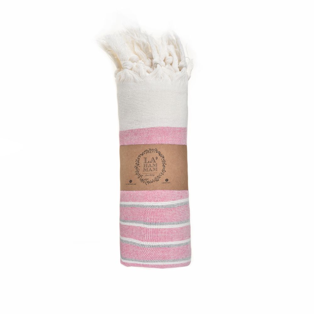 Eftelia Beach Towel displayed on a sandy beach, showcasing its vibrant colors and traditional woven design, perfect for summer outings.