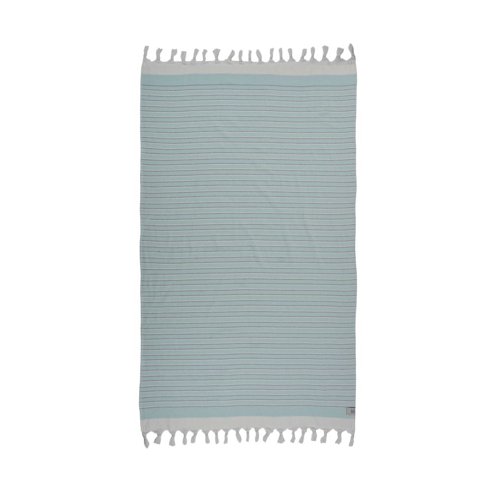 Eftelia Beach Towel displayed on a sandy beach, showcasing its vibrant colors and traditional woven design, perfect for summer outings.