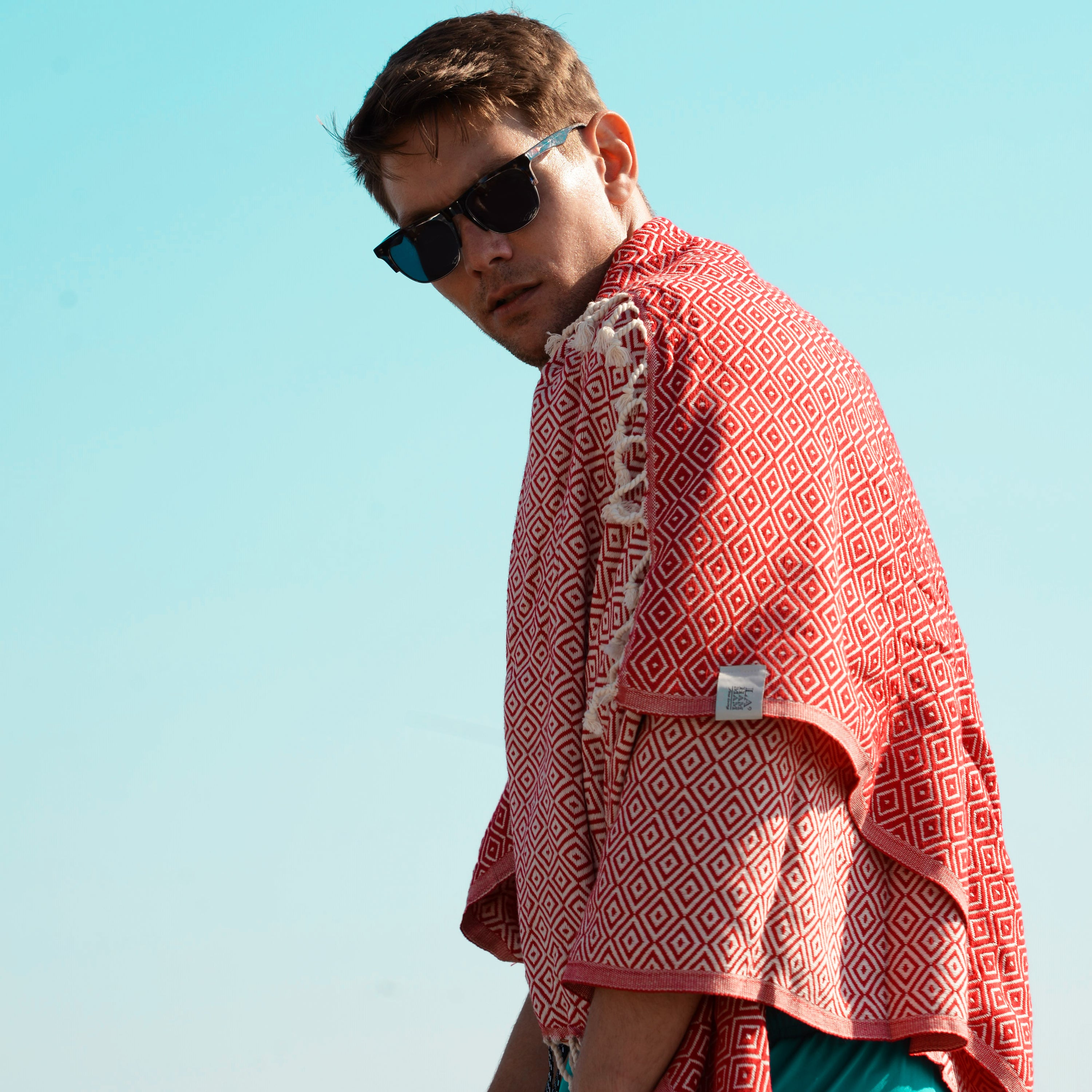 Malta Beach Towel displayed on a sandy beach, showcasing its vibrant colors and traditional woven design, perfect for beach and outdoor activities.