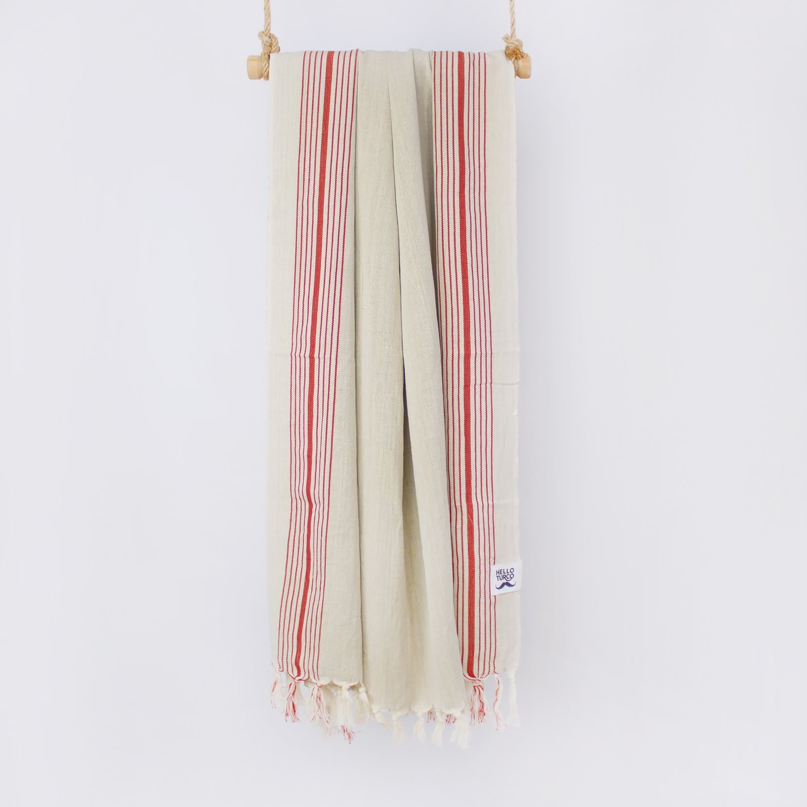 Melek Handwoven Towel featuring a raw beige base with traditional red lines, showcasing its artisanal craftsmanship and organic cotton material.