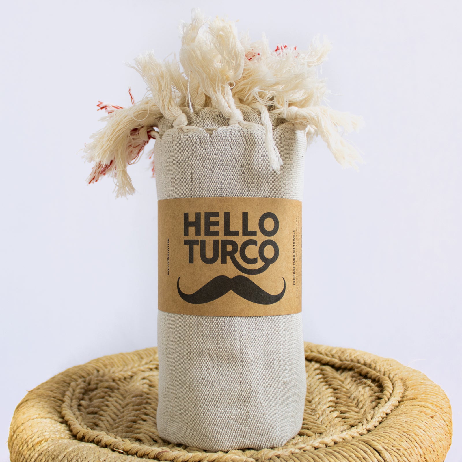 Melek Handwoven Towel featuring a raw beige base with traditional red lines, showcasing its artisanal craftsmanship and organic cotton material.