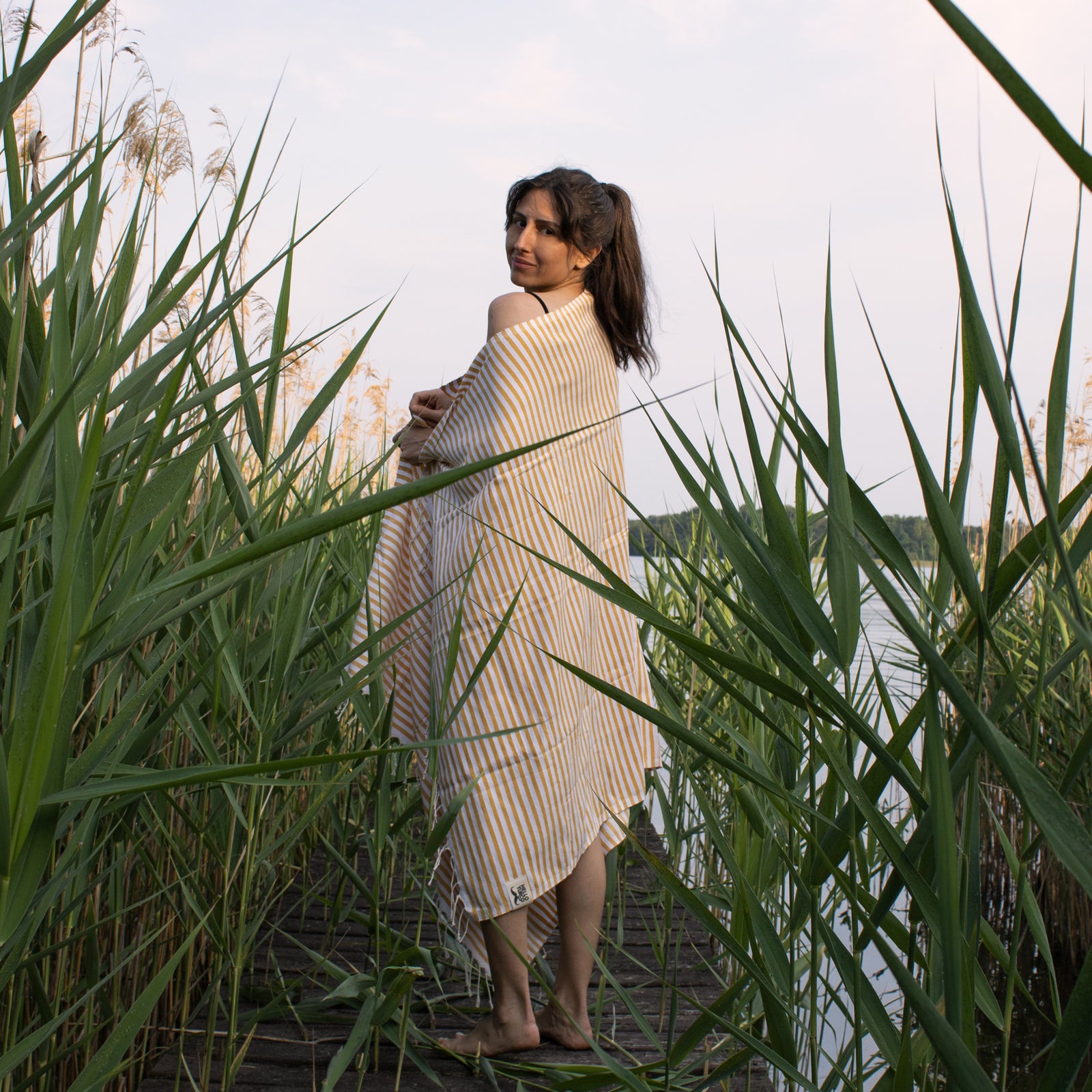 Soni Turkish Towel featuring a classic yellow striped design, made of 100% organic cotton, perfect for beach and spa use.