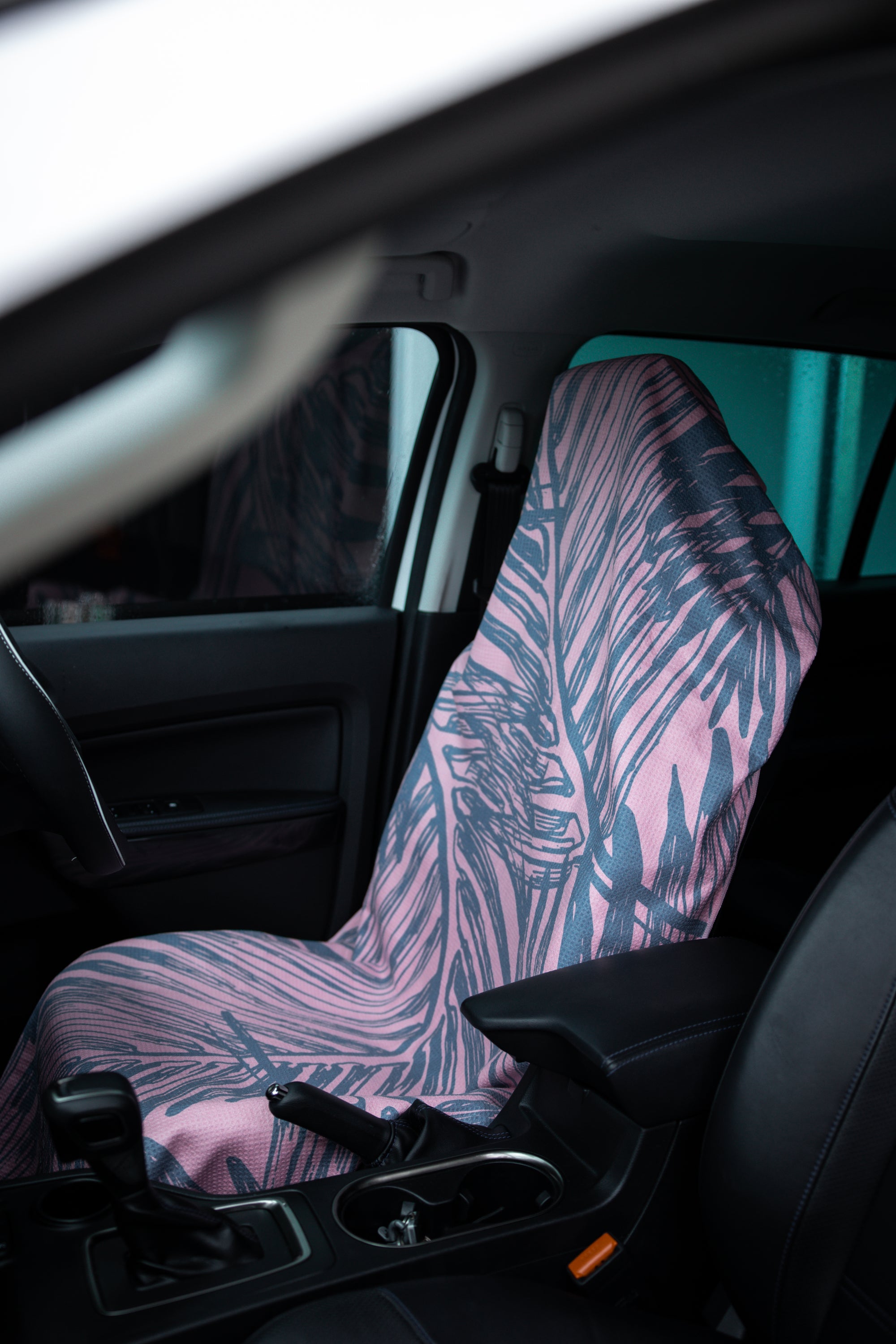 The Rainforest Pink towel featuring a vibrant rainforest-inspired design in three colors, showcasing its absorbent and quick-drying microfiber material.