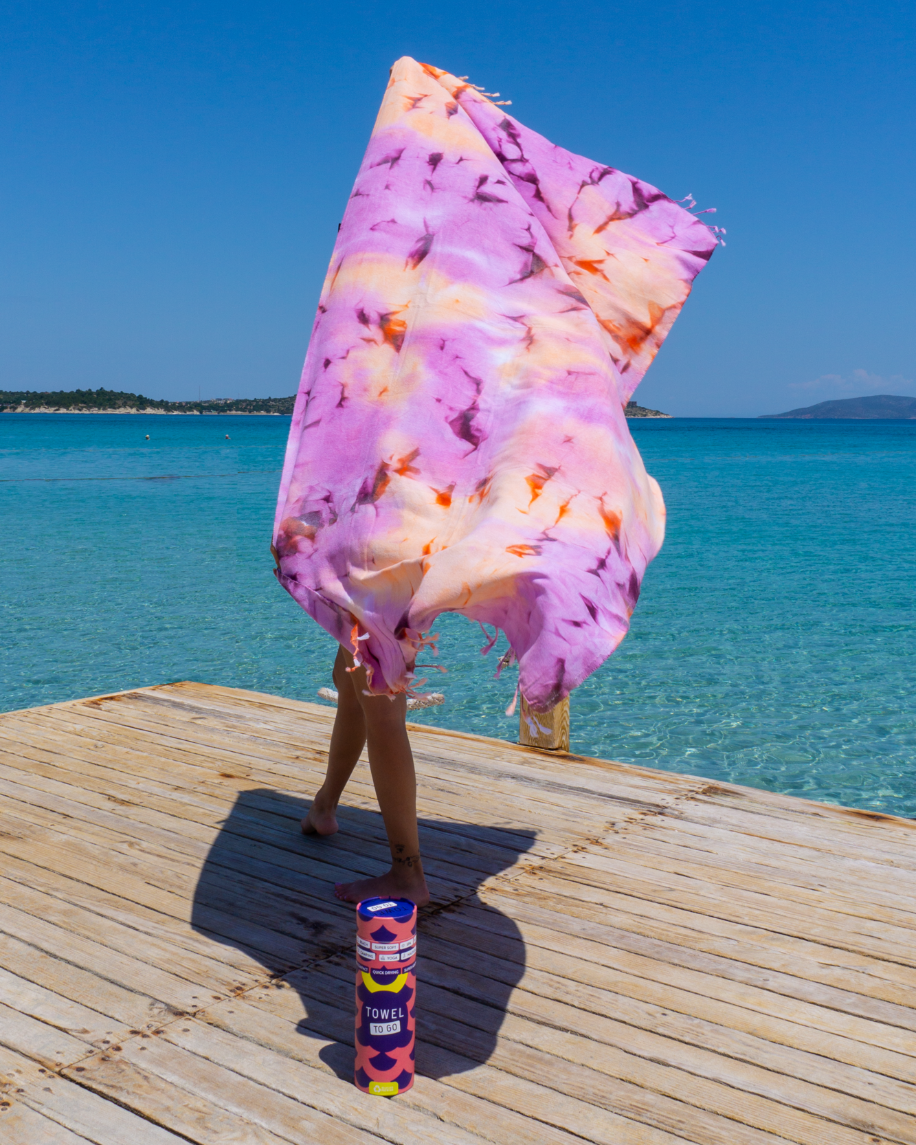 A vibrant purple tie dye convertible towel kimono displayed elegantly, showcasing its unique design and soft texture, perfect for beach or poolside use.