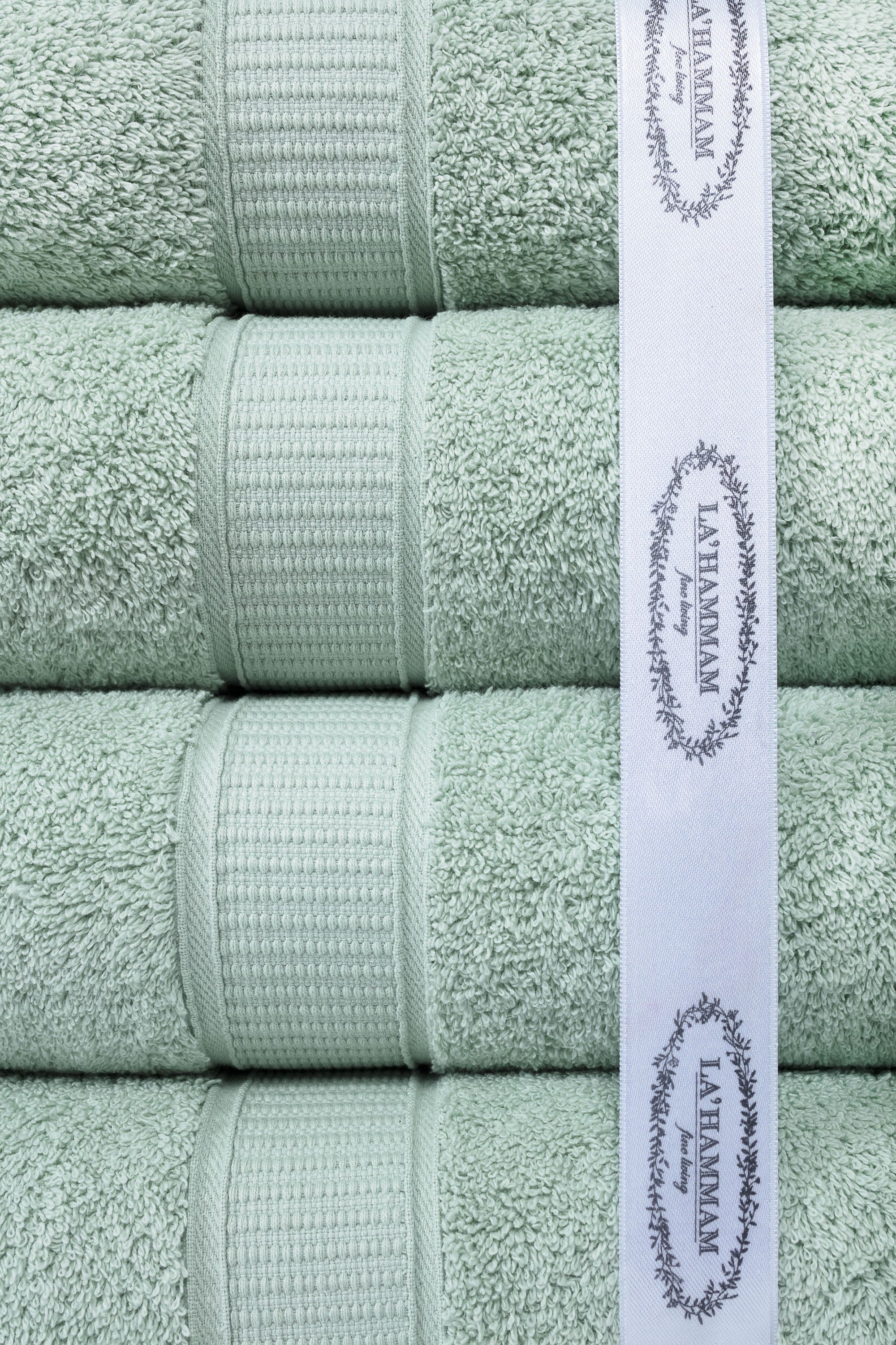 A luxurious set of 6 Turkish cotton bath towels in vibrant colors, showcasing their softness and dobby border design.