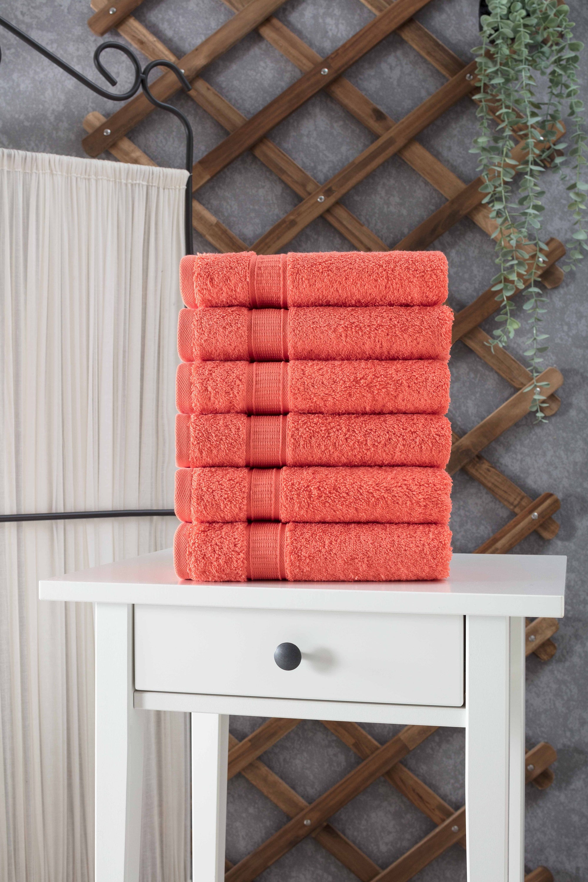 A set of six luxurious Turkish cotton hand towels in various vibrant colors, showcasing their soft texture and elegant dobby border design.