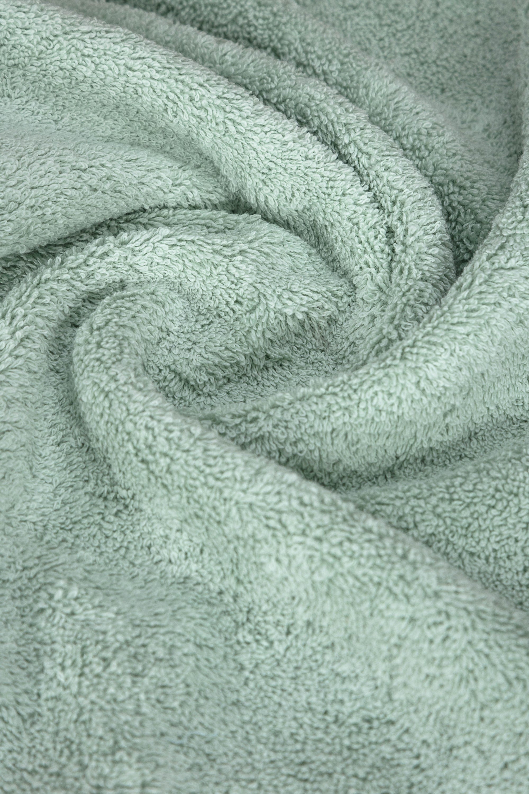 A set of six luxurious Turkish cotton hand towels in various vibrant colors, showcasing their soft texture and elegant dobby border design.