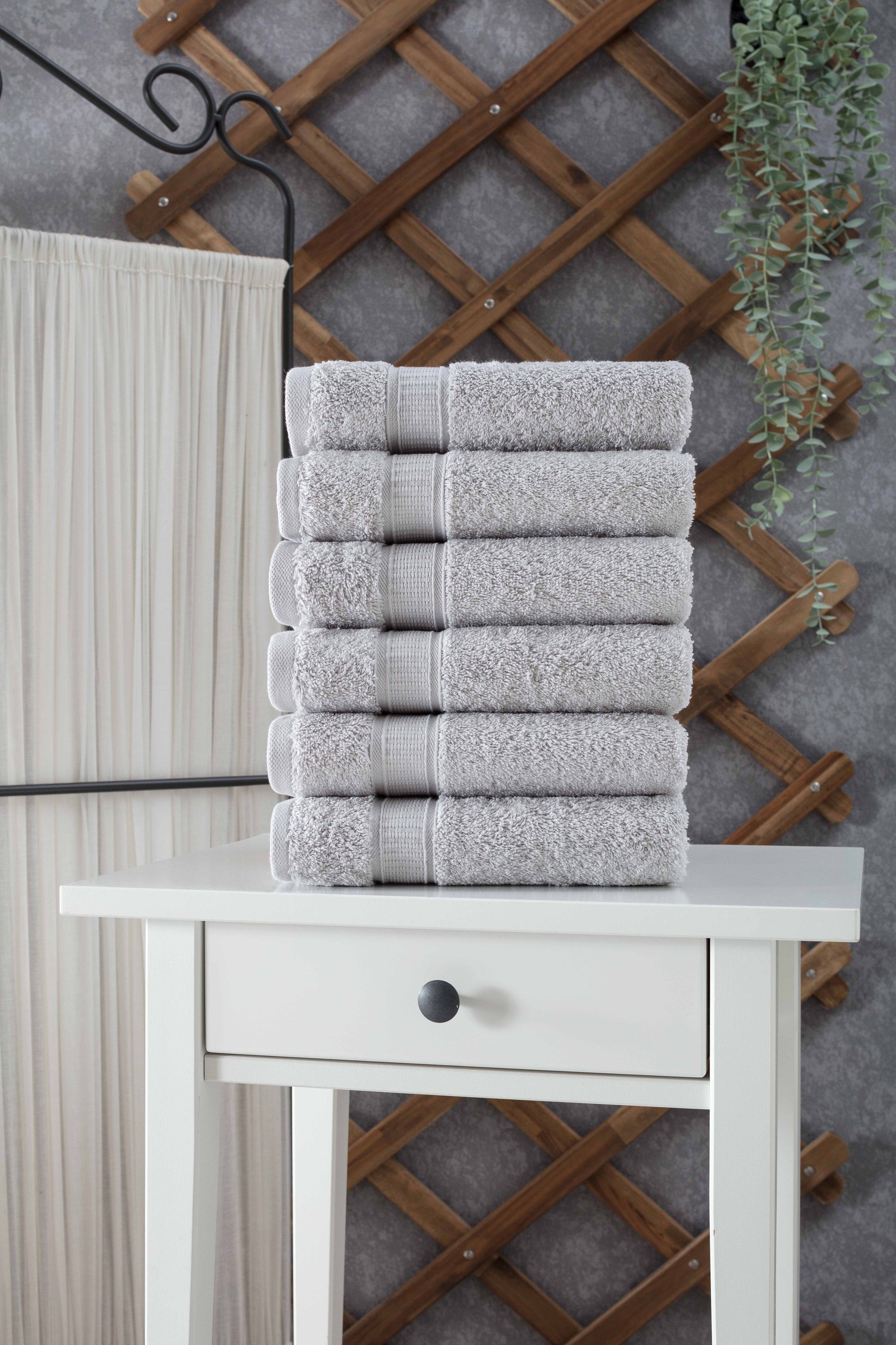 A set of six luxurious Turkish cotton hand towels in various vibrant colors, showcasing their soft texture and elegant dobby border design.