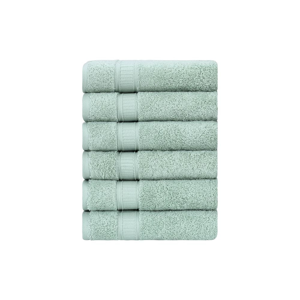 A set of six luxurious Turkish cotton hand towels in various vibrant colors, showcasing their soft texture and elegant dobby border design.